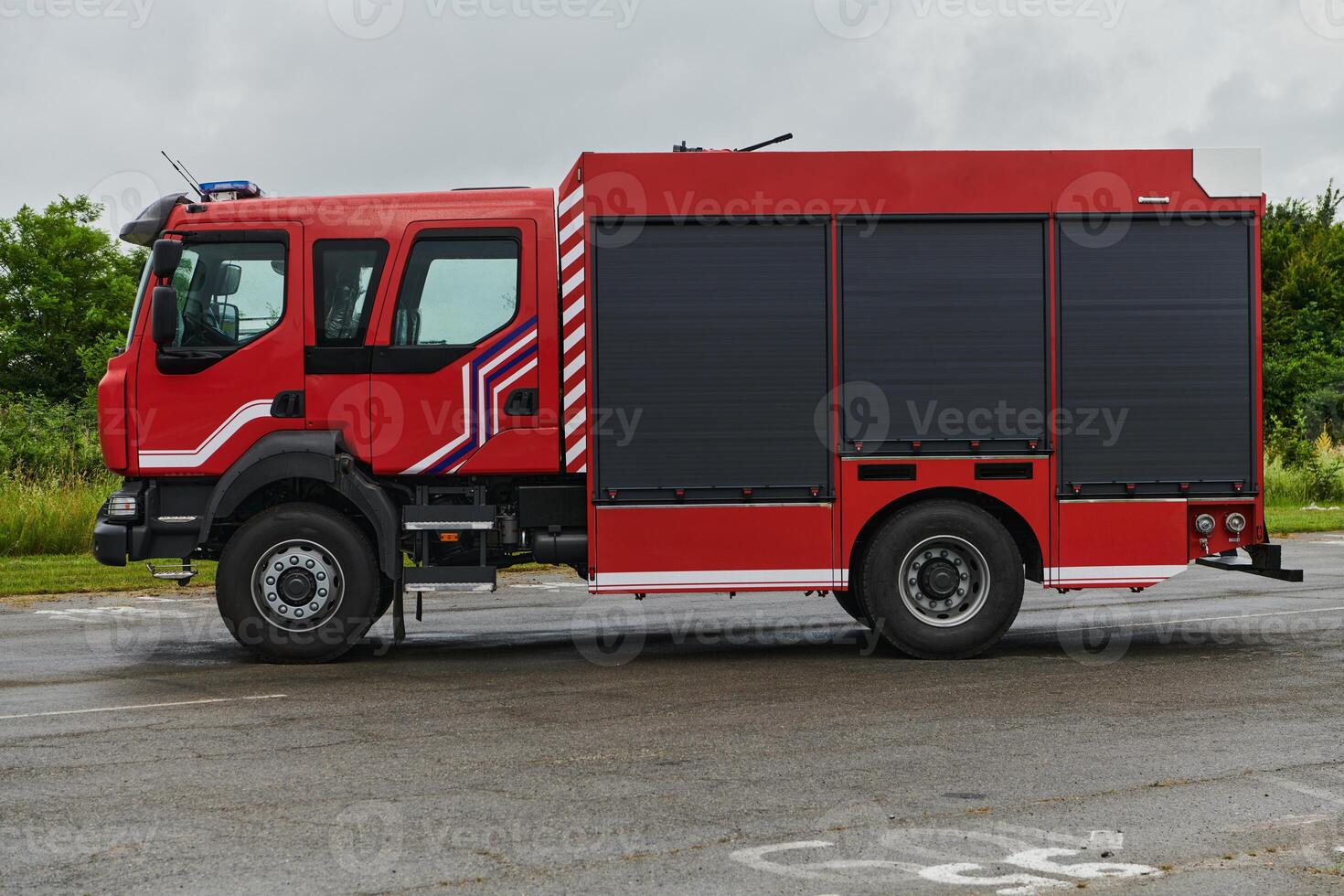 In this captivating scene, a state-of-the-art firetruck, equipped with advanced rescue technology, stands ready with its skilled firefighting team, prepared to intervene and respond rapidly to photo