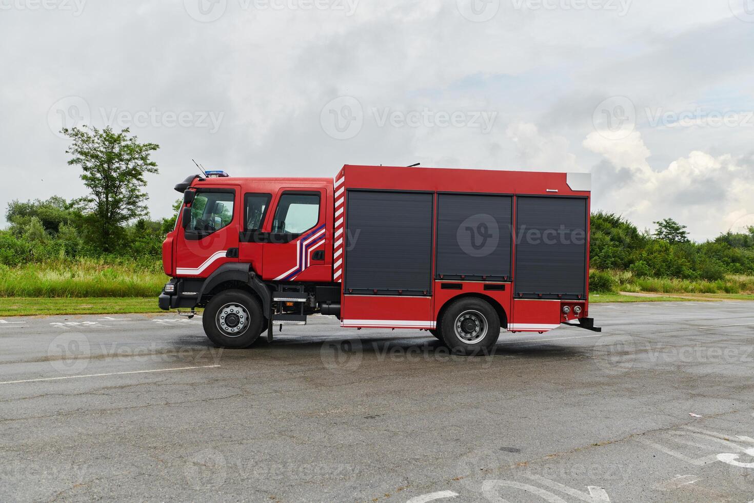 In this captivating scene, a state-of-the-art firetruck, equipped with advanced rescue technology, stands ready with its skilled firefighting team, prepared to intervene and respond rapidly to photo