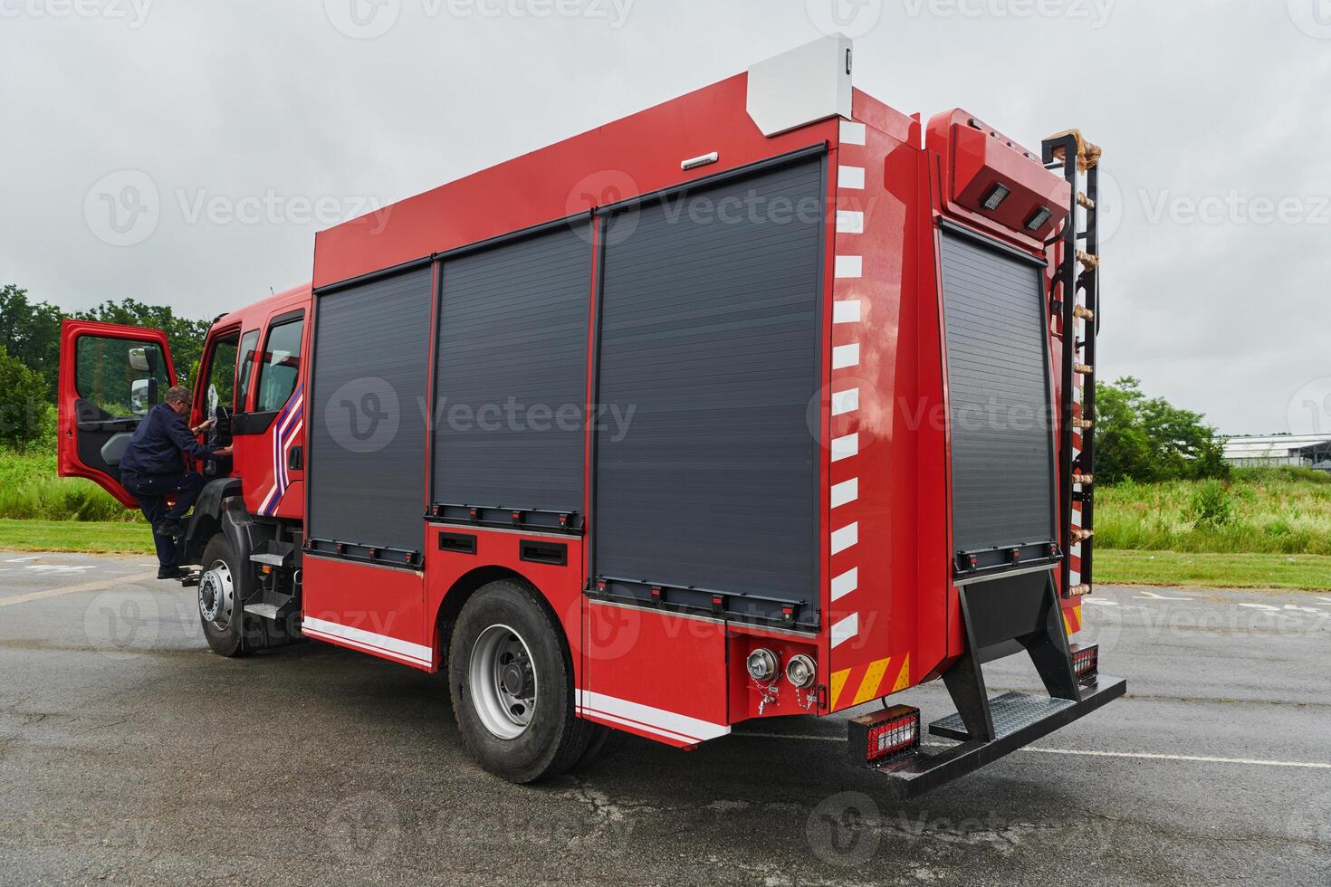 In this captivating scene, a state-of-the-art firetruck, equipped with advanced rescue technology, stands ready with its skilled firefighting team, prepared to intervene and respond rapidly to photo