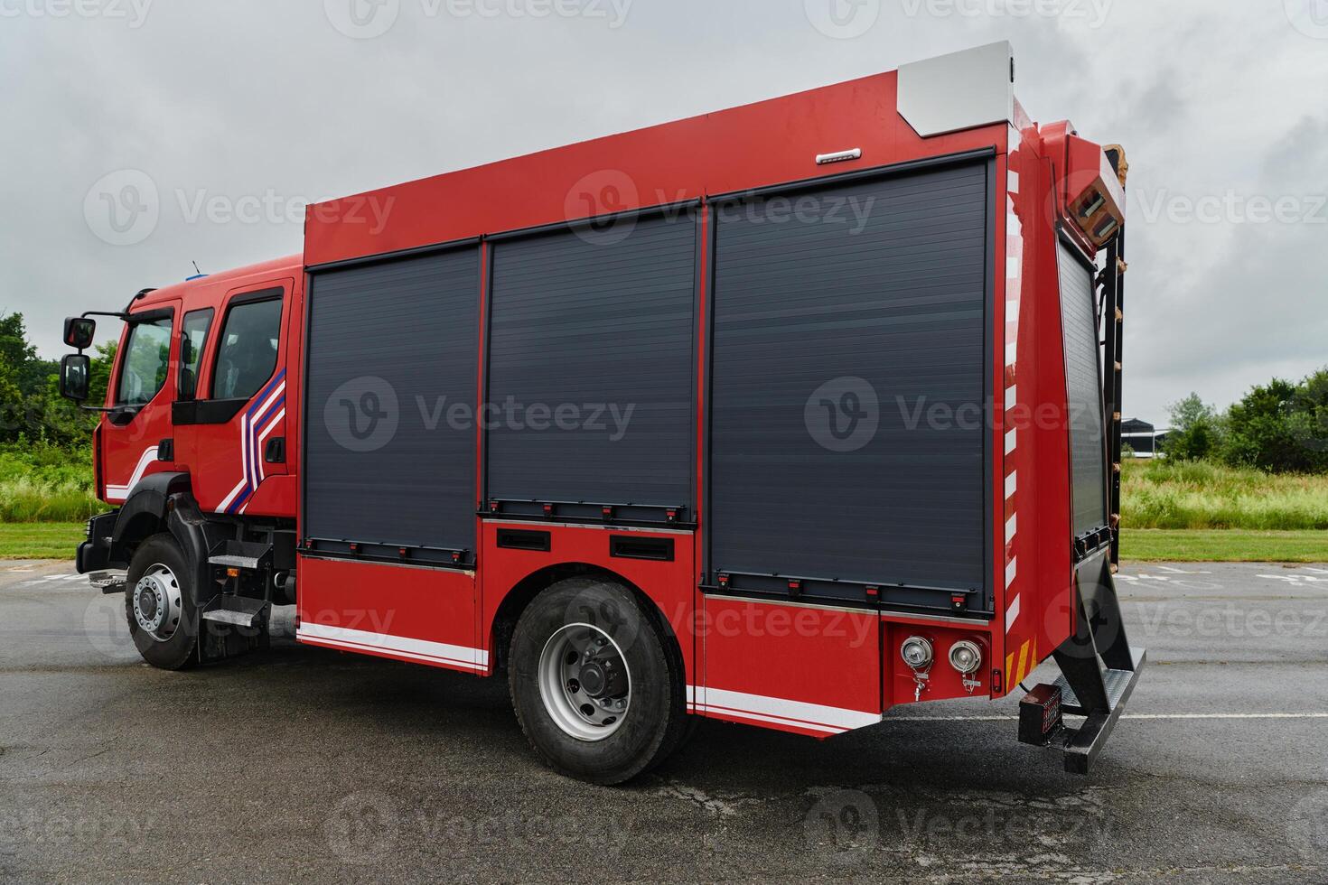 In this captivating scene, a state-of-the-art firetruck, equipped with advanced rescue technology, stands ready with its skilled firefighting team, prepared to intervene and respond rapidly to photo