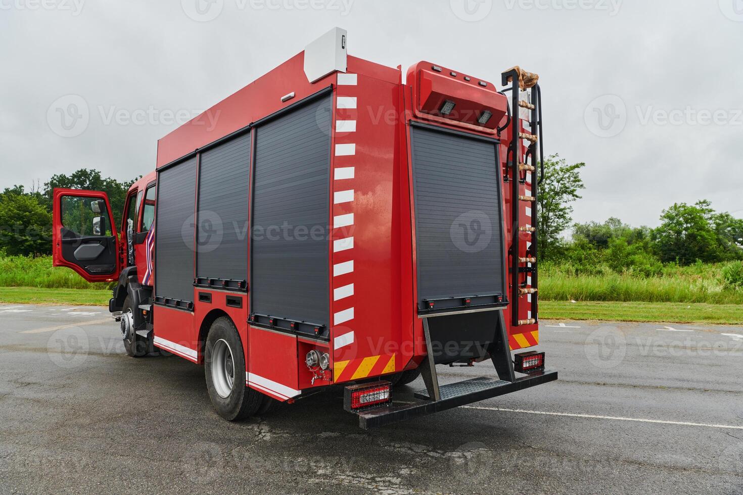 In this captivating scene, a state-of-the-art firetruck, equipped with advanced rescue technology, stands ready with its skilled firefighting team, prepared to intervene and respond rapidly to photo