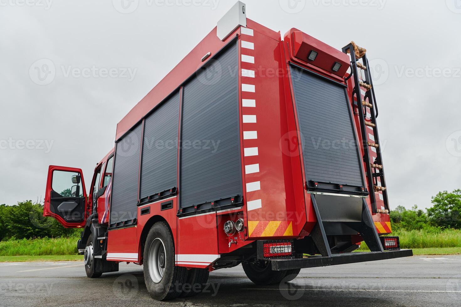 In this captivating scene, a state-of-the-art firetruck, equipped with advanced rescue technology, stands ready with its skilled firefighting team, prepared to intervene and respond rapidly to photo