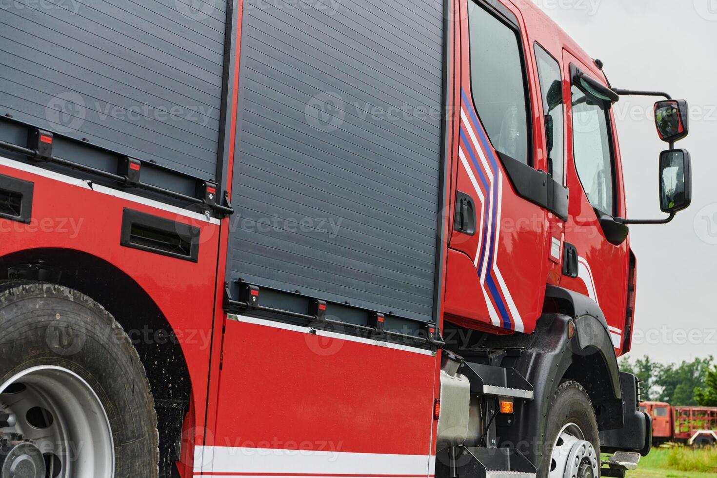 In this captivating scene, a state-of-the-art firetruck, equipped with advanced rescue technology, stands ready with its skilled firefighting team, prepared to intervene and respond rapidly to photo