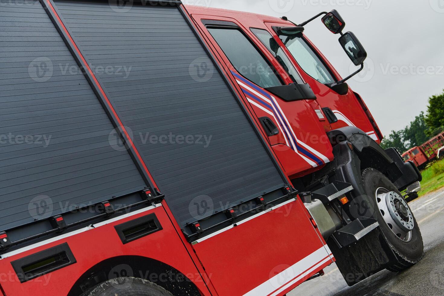 In this captivating scene, a state-of-the-art firetruck, equipped with advanced rescue technology, stands ready with its skilled firefighting team, prepared to intervene and respond rapidly to photo
