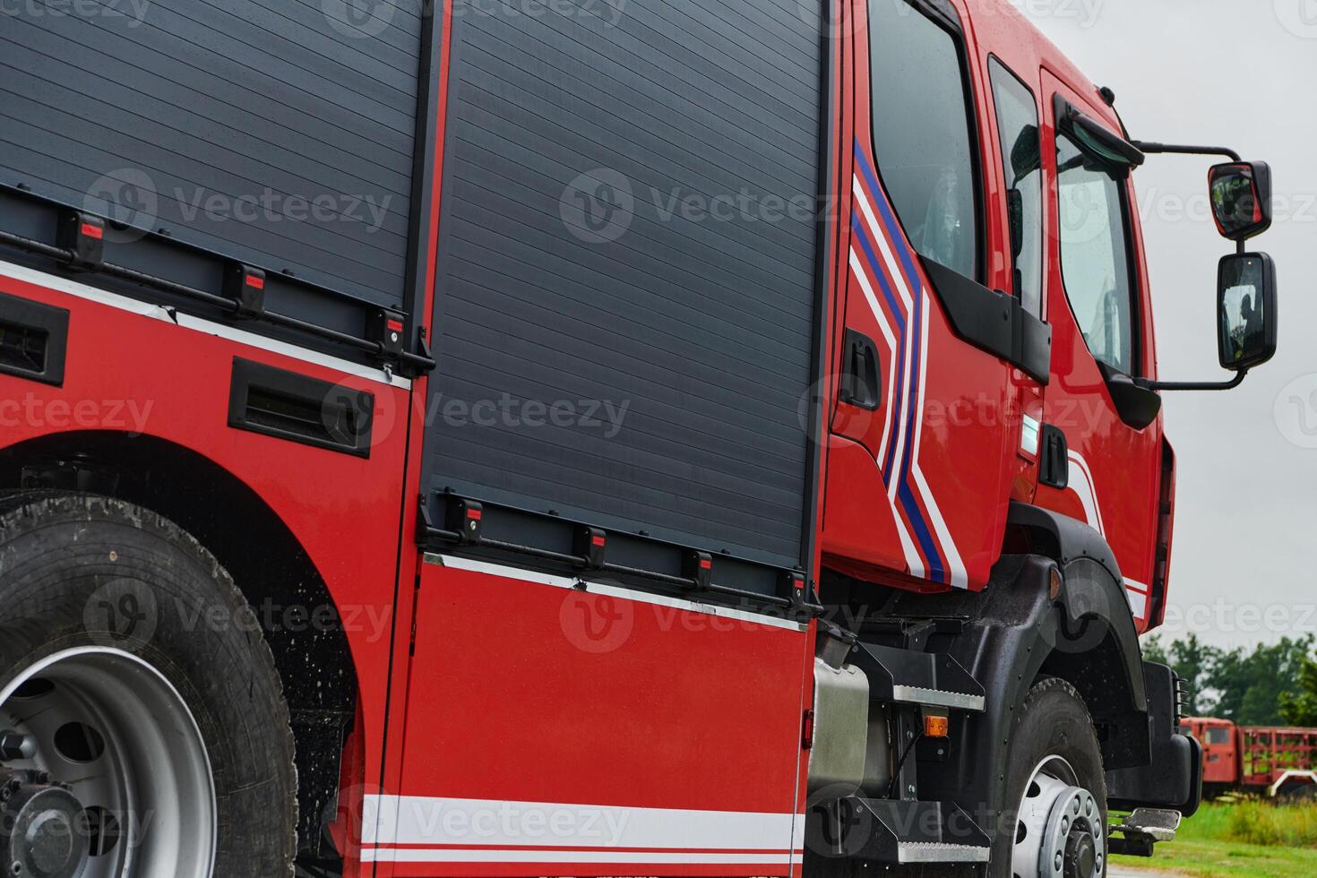 In this captivating scene, a state-of-the-art firetruck, equipped with advanced rescue technology, stands ready with its skilled firefighting team, prepared to intervene and respond rapidly to photo