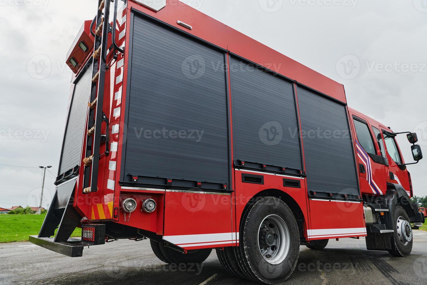 In this captivating scene, a state-of-the-art firetruck, equipped with advanced rescue technology, stands ready with its skilled firefighting team, prepared to intervene and respond rapidly to photo