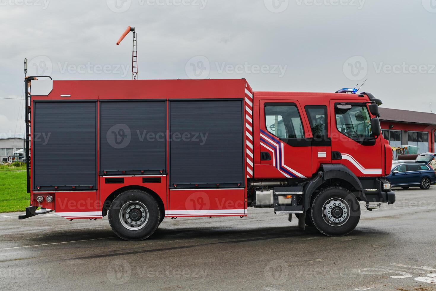 In this captivating scene, a state-of-the-art firetruck, equipped with advanced rescue technology, stands ready with its skilled firefighting team, prepared to intervene and respond rapidly to photo