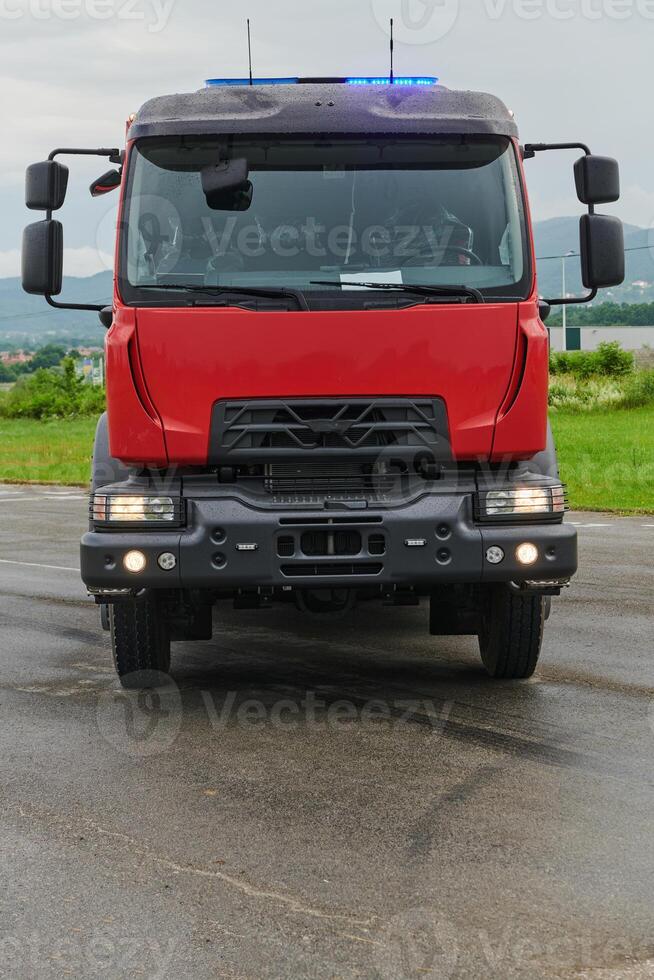 In this captivating scene, a state-of-the-art firetruck, equipped with advanced rescue technology, stands ready with its skilled firefighting team, prepared to intervene and respond rapidly to photo