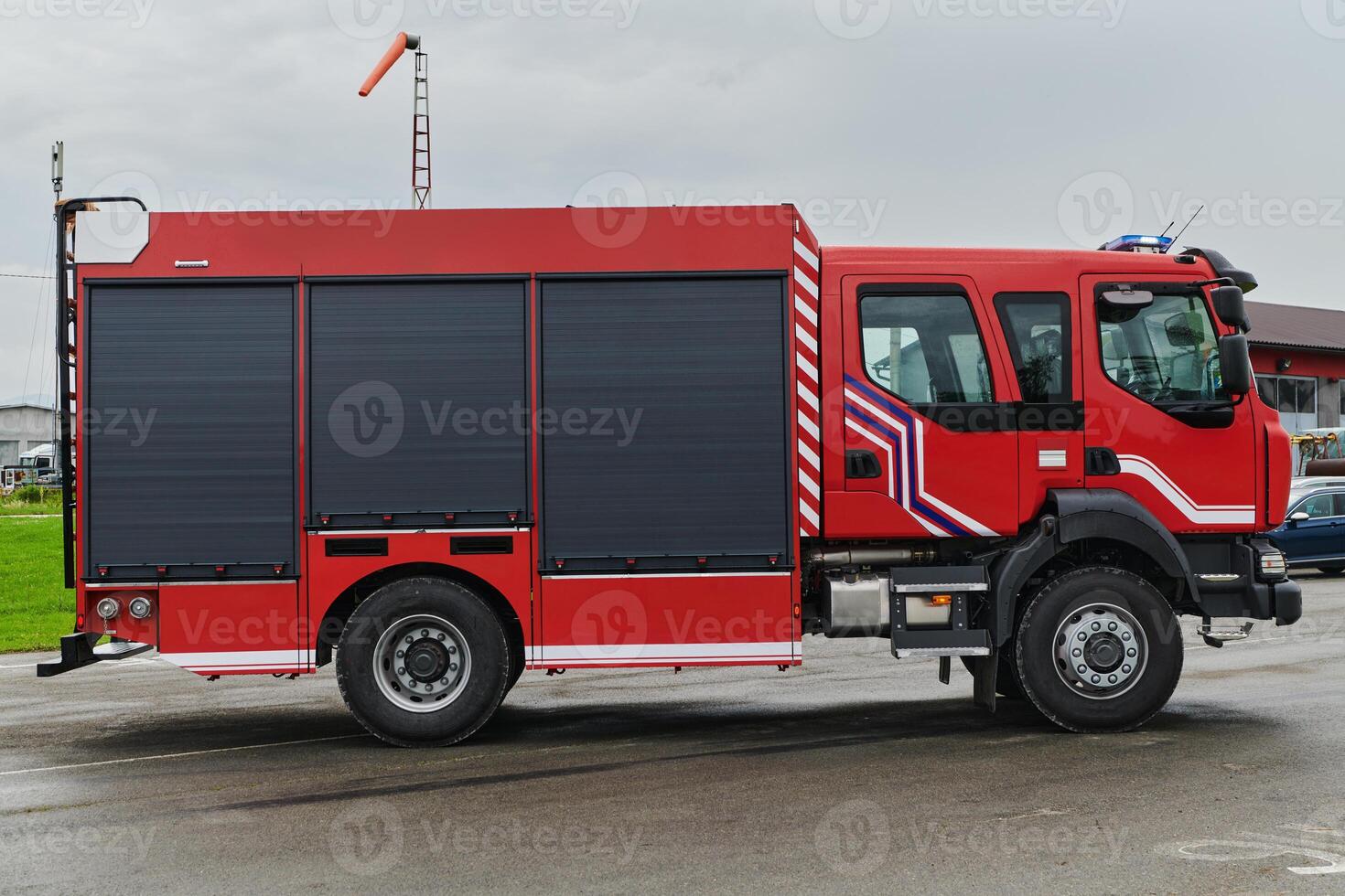 In this captivating scene, a state-of-the-art firetruck, equipped with advanced rescue technology, stands ready with its skilled firefighting team, prepared to intervene and respond rapidly to photo