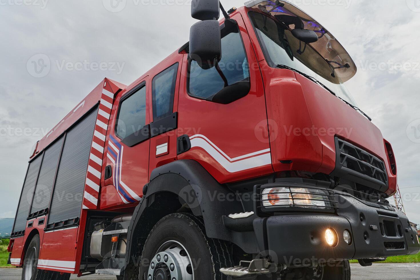 In this captivating scene, a state-of-the-art firetruck, equipped with advanced rescue technology, stands ready with its skilled firefighting team, prepared to intervene and respond rapidly to photo
