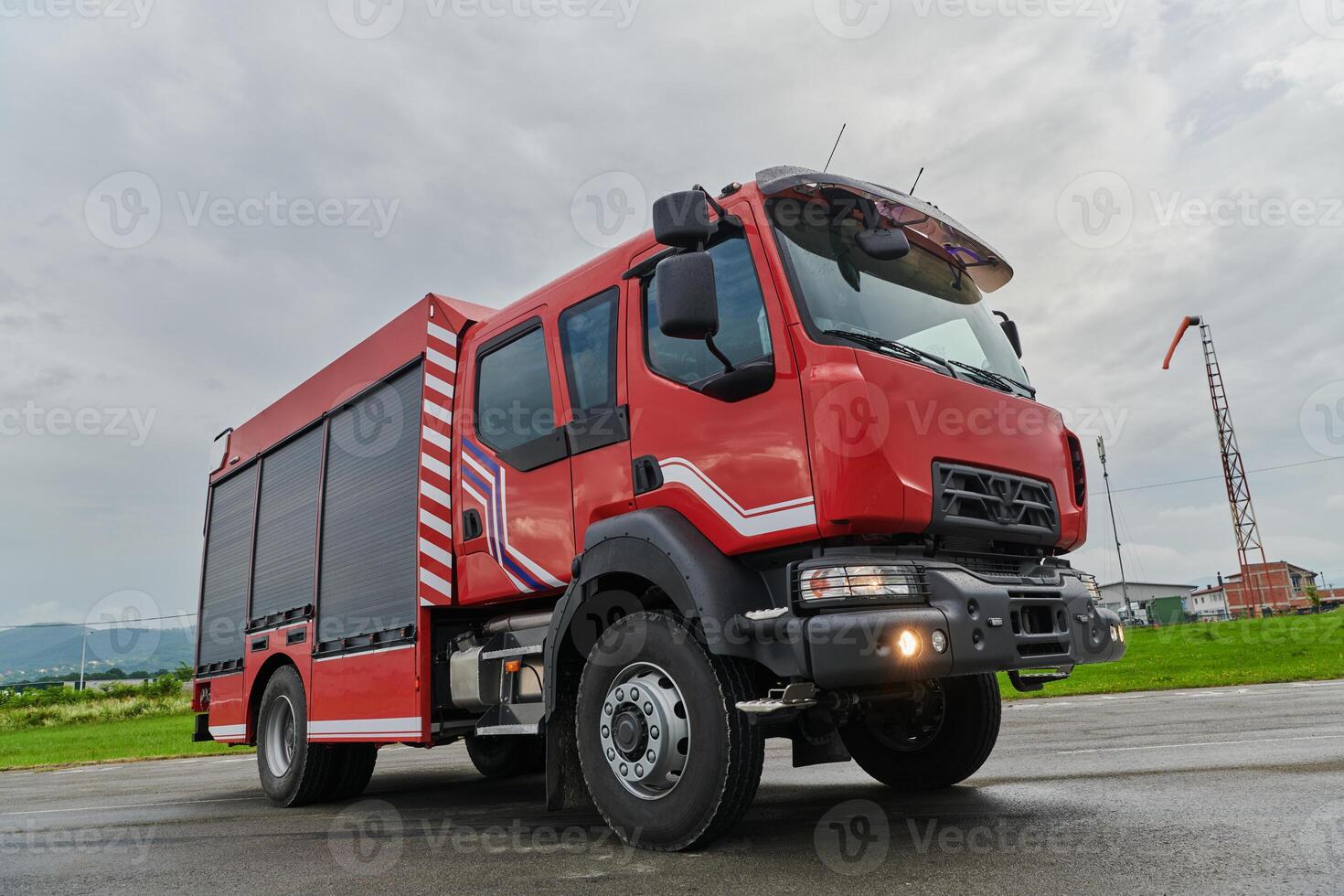 In this captivating scene, a state-of-the-art firetruck, equipped with advanced rescue technology, stands ready with its skilled firefighting team, prepared to intervene and respond rapidly to photo