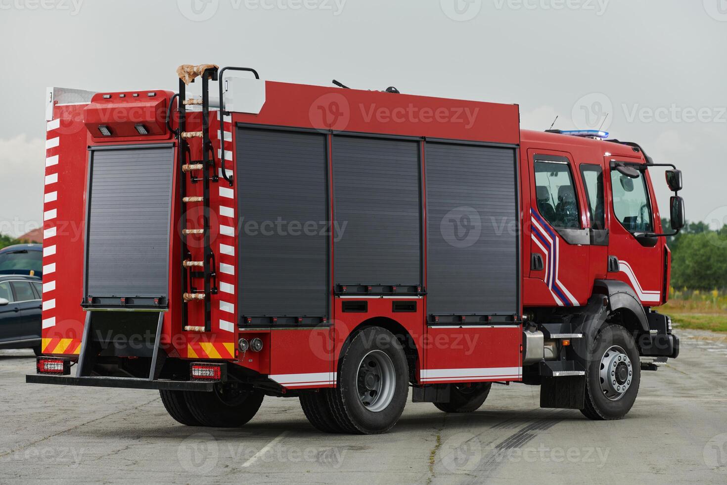 In this captivating scene, a state-of-the-art firetruck, equipped with advanced rescue technology, stands ready with its skilled firefighting team, prepared to intervene and respond rapidly to photo