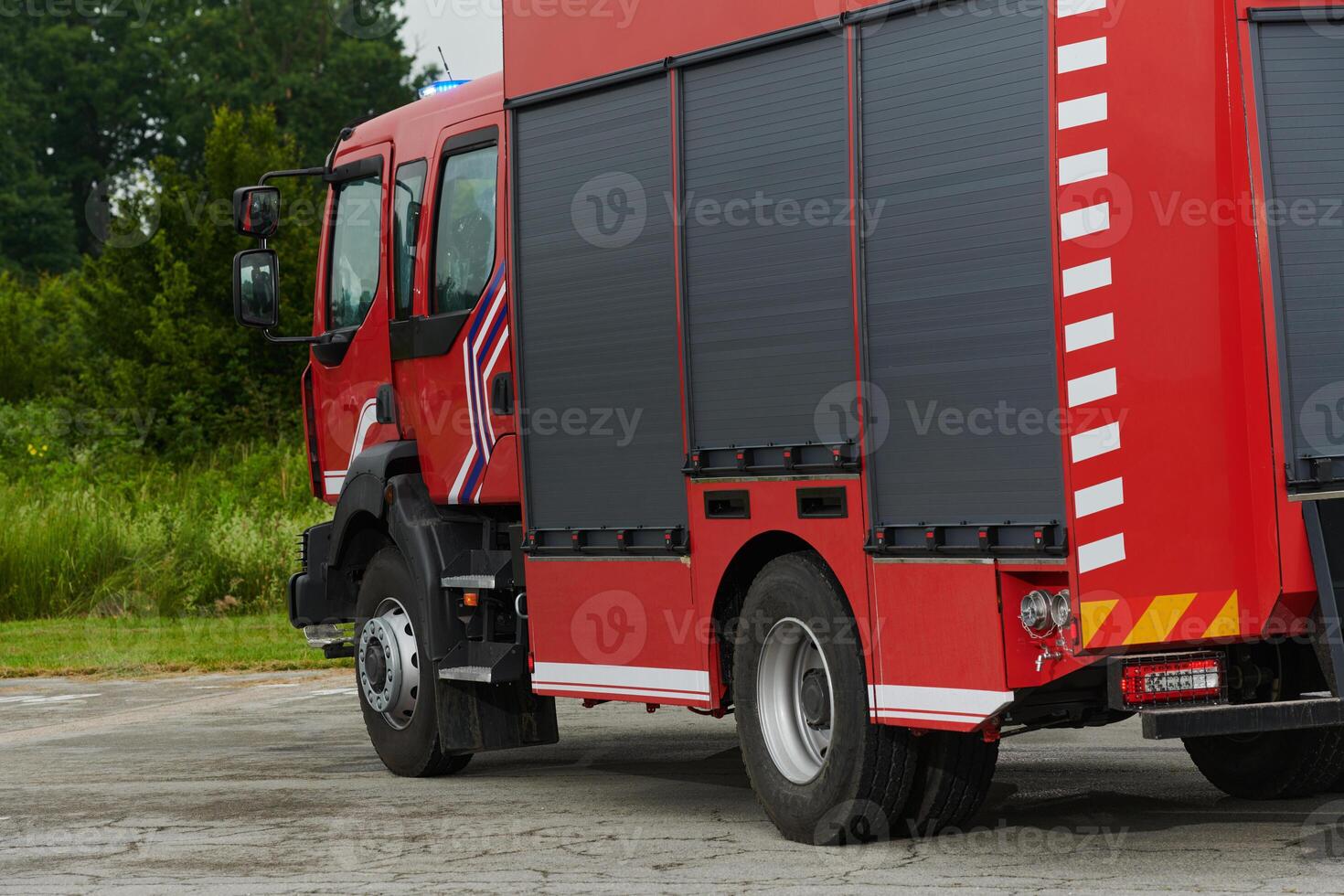 In this captivating scene, a state-of-the-art firetruck, equipped with advanced rescue technology, stands ready with its skilled firefighting team, prepared to intervene and respond rapidly to photo