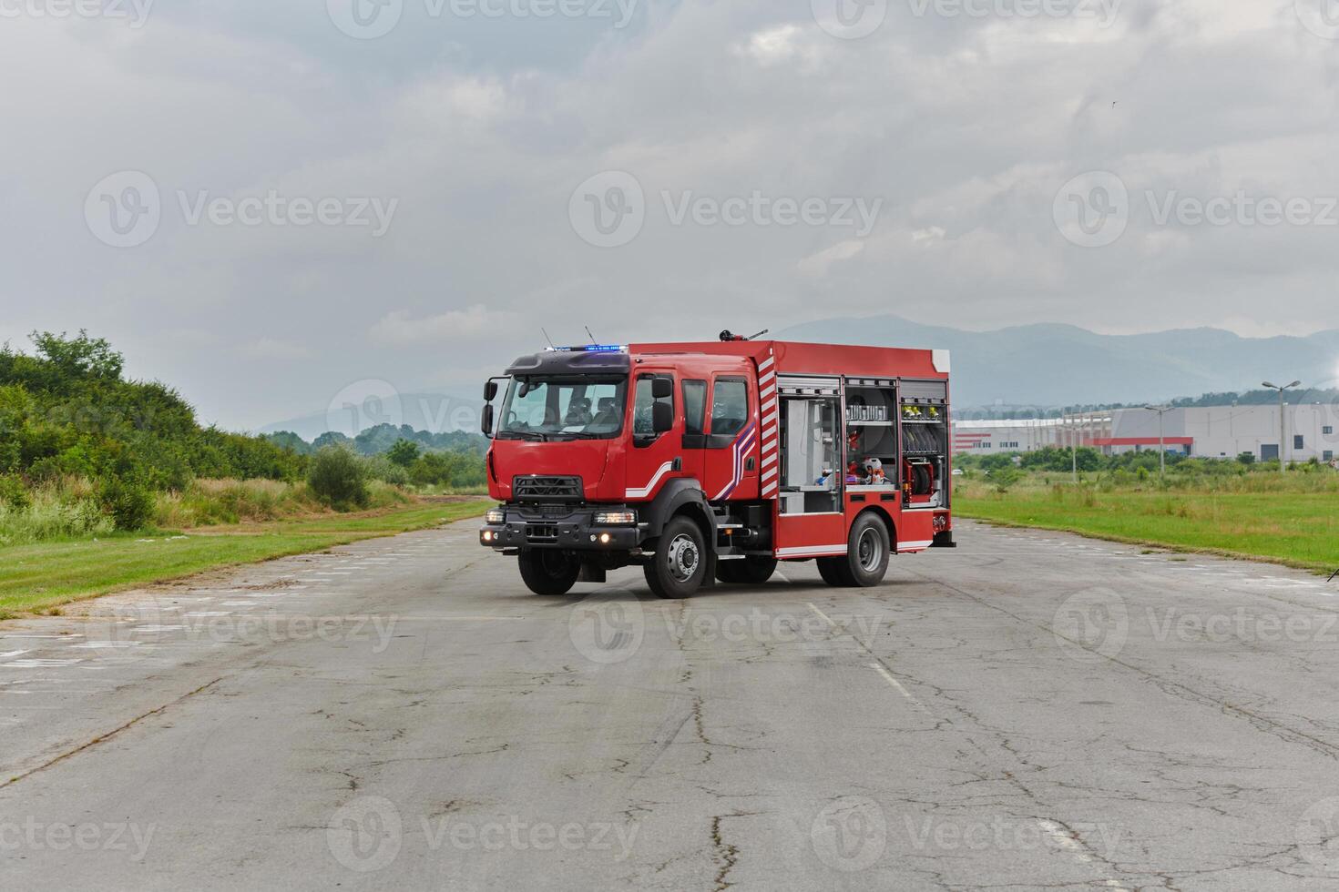 In this captivating scene, a state-of-the-art firetruck, equipped with advanced rescue technology, stands ready with its skilled firefighting team, prepared to intervene and respond rapidly to photo