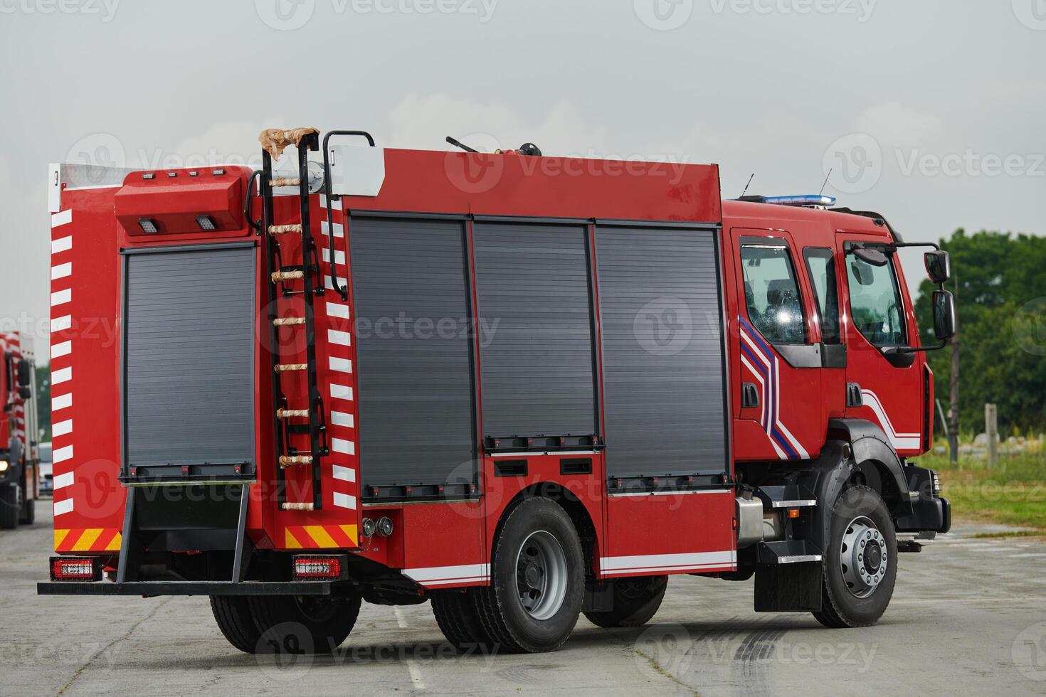 In this captivating scene, a state-of-the-art firetruck, equipped with advanced rescue technology, stands ready with its skilled firefighting team, prepared to intervene and respond rapidly to photo