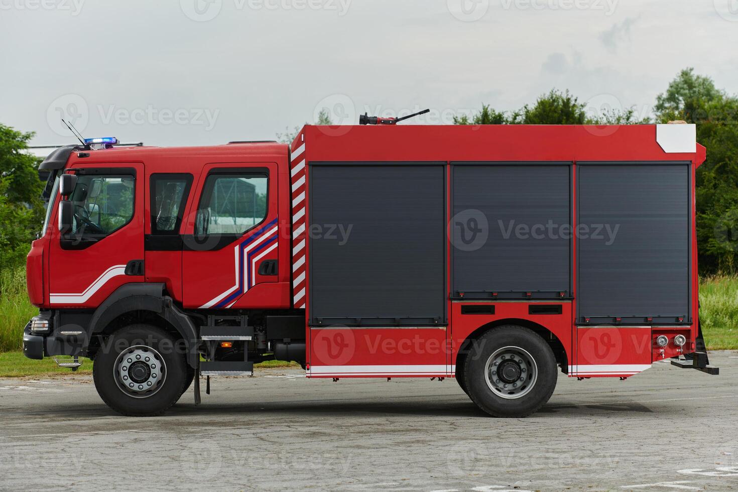 In this captivating scene, a state-of-the-art firetruck, equipped with advanced rescue technology, stands ready with its skilled firefighting team, prepared to intervene and respond rapidly to photo
