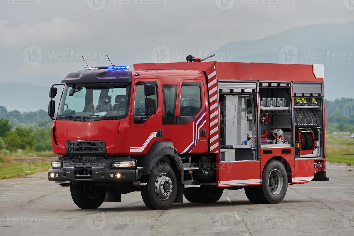 In this captivating scene, a state-of-the-art firetruck, equipped with advanced rescue technology, stands ready with its skilled firefighting team, prepared to intervene and respond rapidly to photo
