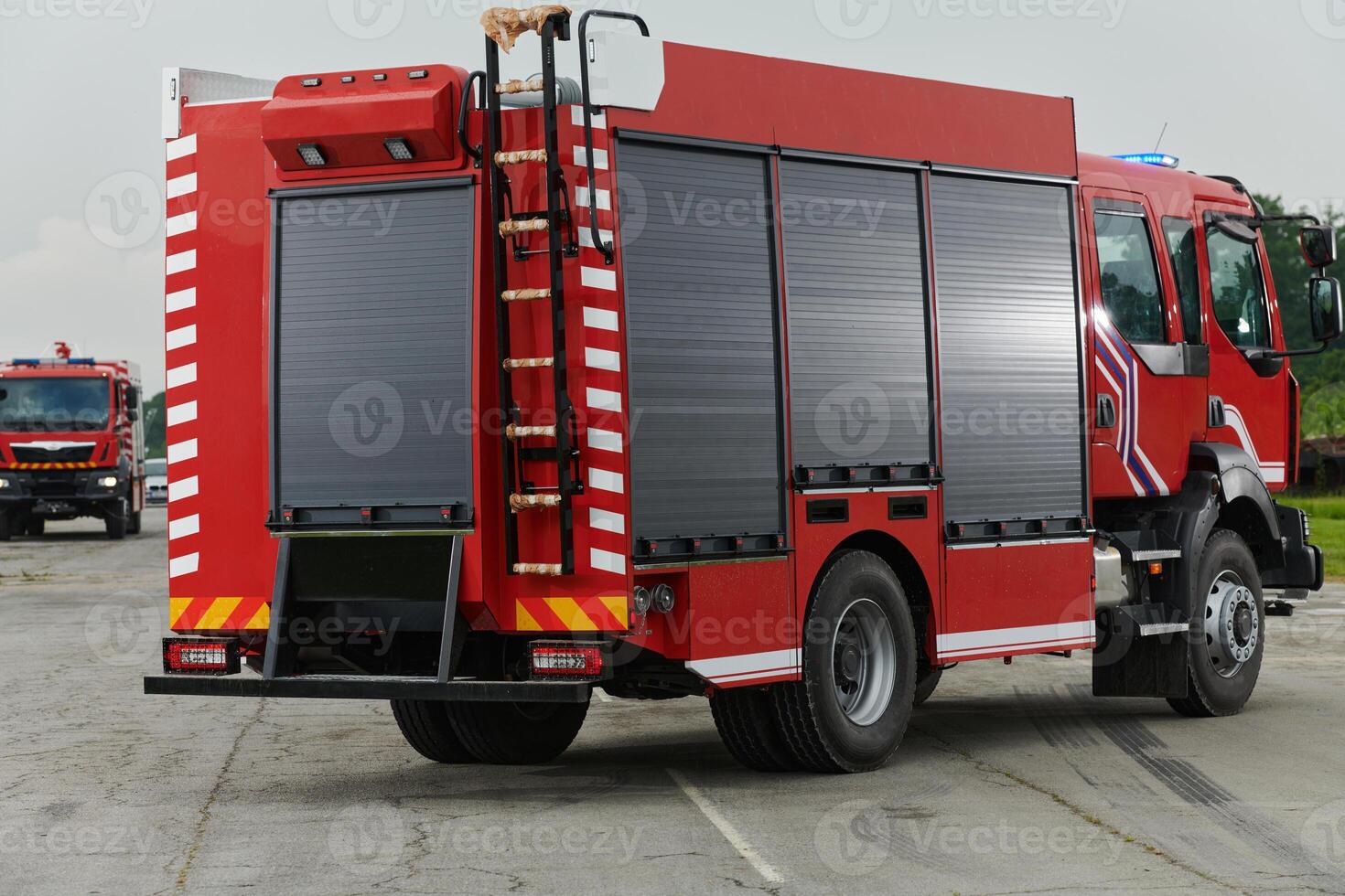 In this captivating scene, a state-of-the-art firetruck, equipped with advanced rescue technology, stands ready with its skilled firefighting team, prepared to intervene and respond rapidly to photo