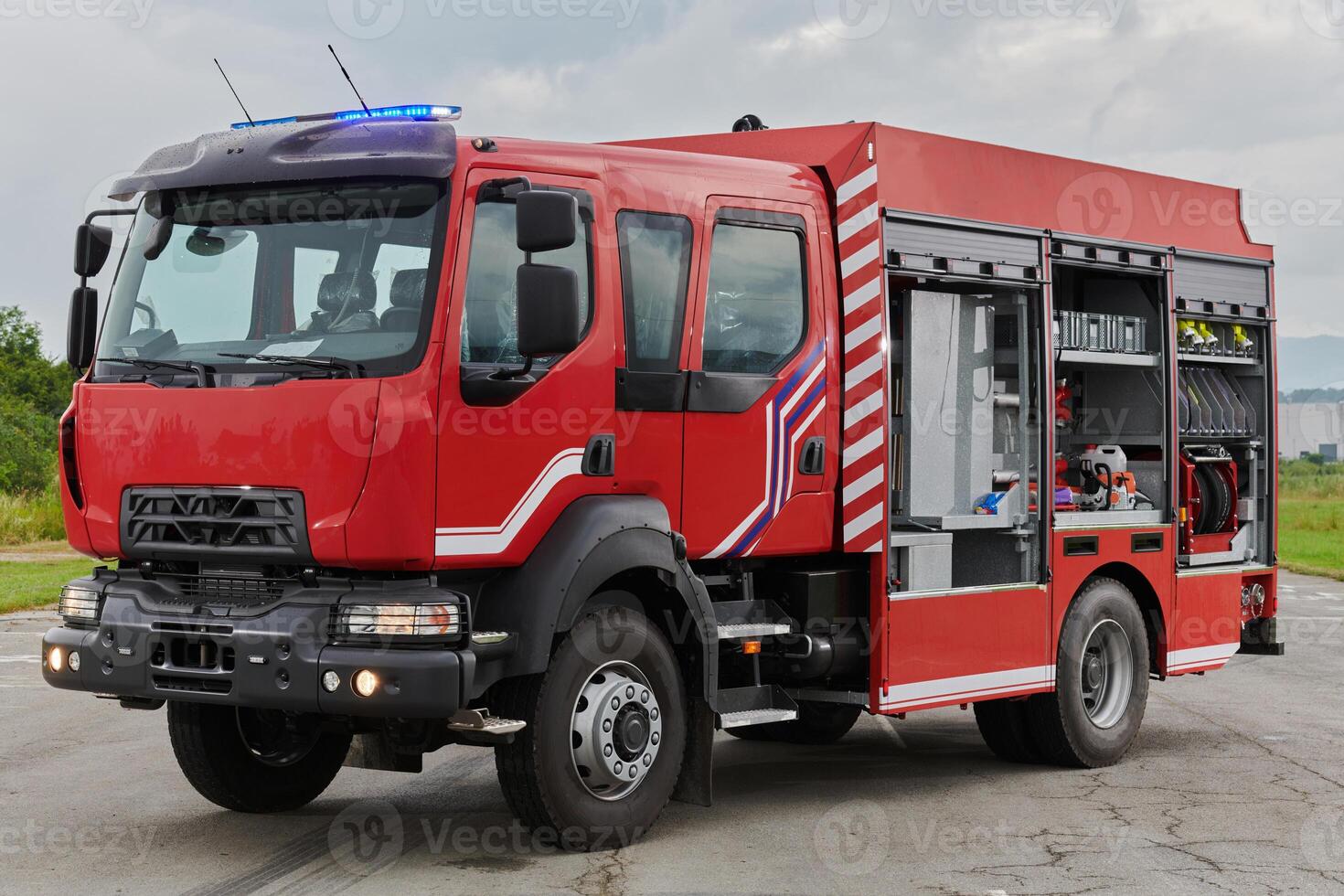 In this captivating scene, a state-of-the-art firetruck, equipped with advanced rescue technology, stands ready with its skilled firefighting team, prepared to intervene and respond rapidly to photo