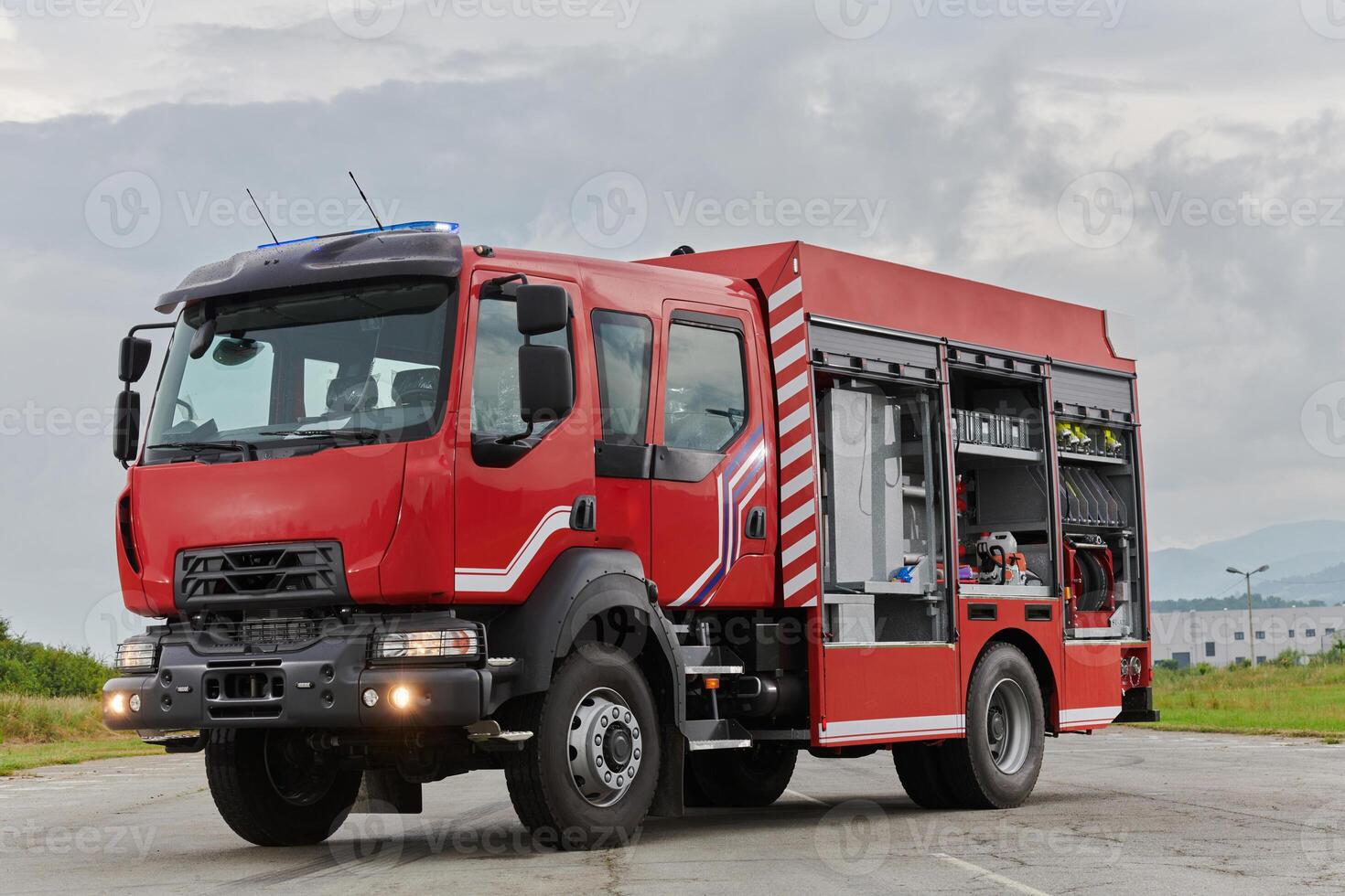 In this captivating scene, a state-of-the-art firetruck, equipped with advanced rescue technology, stands ready with its skilled firefighting team, prepared to intervene and respond rapidly to photo