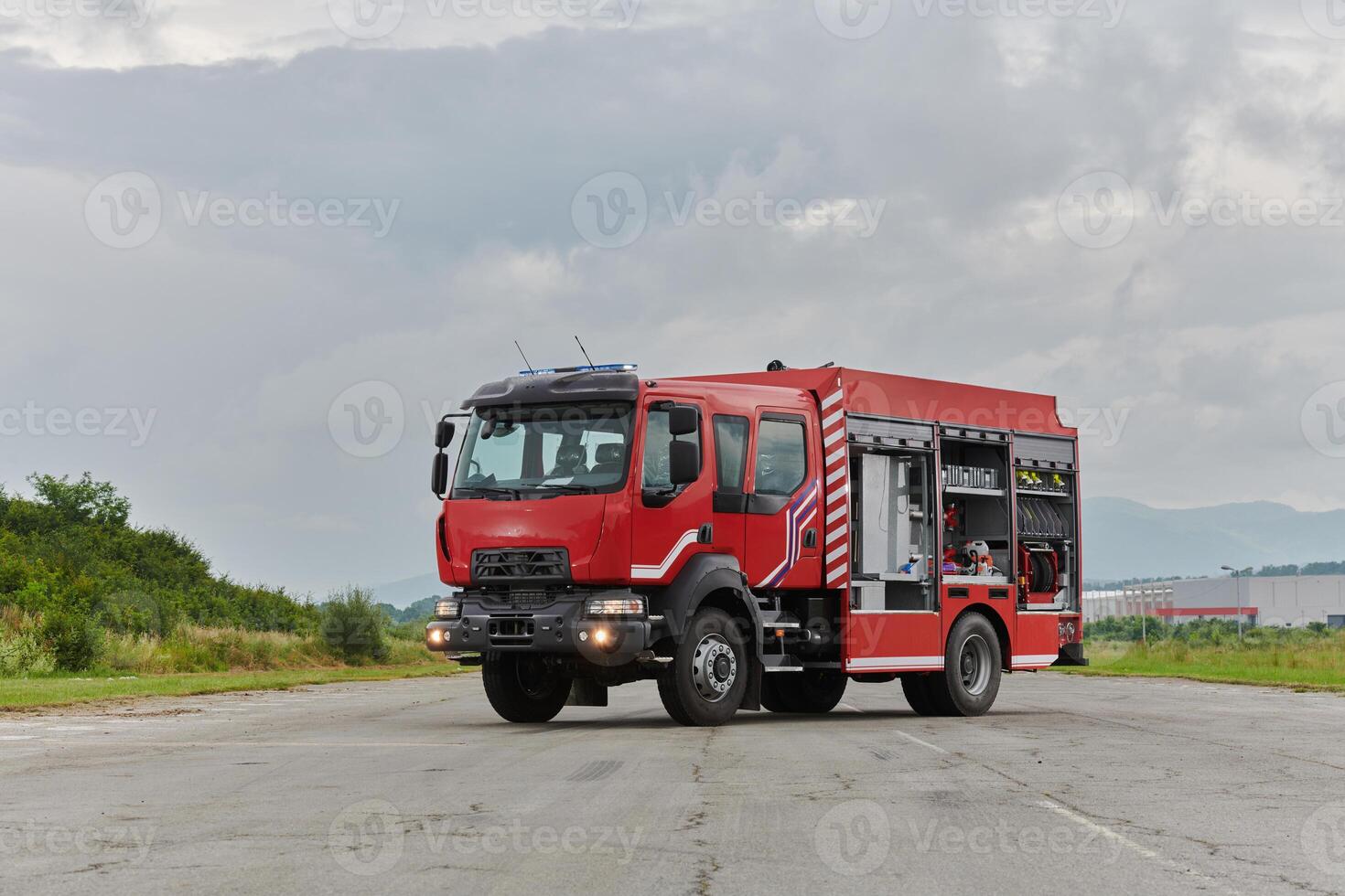 In this captivating scene, a state-of-the-art firetruck, equipped with advanced rescue technology, stands ready with its skilled firefighting team, prepared to intervene and respond rapidly to photo