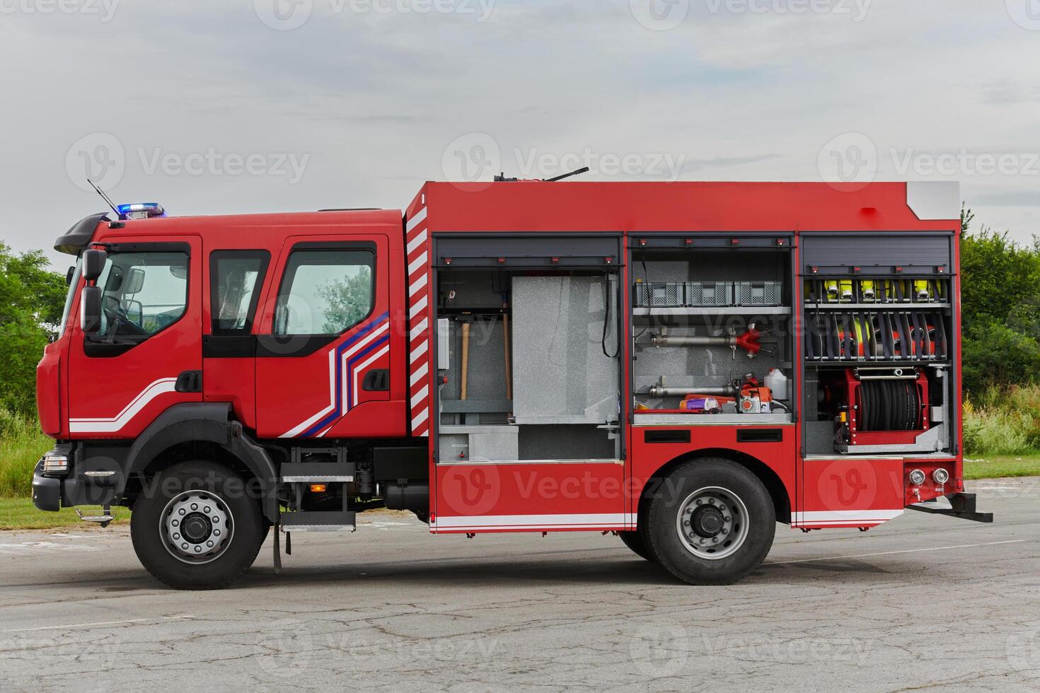 In this captivating scene, a state-of-the-art firetruck, equipped with advanced rescue technology, stands ready with its skilled firefighting team, prepared to intervene and respond rapidly to photo