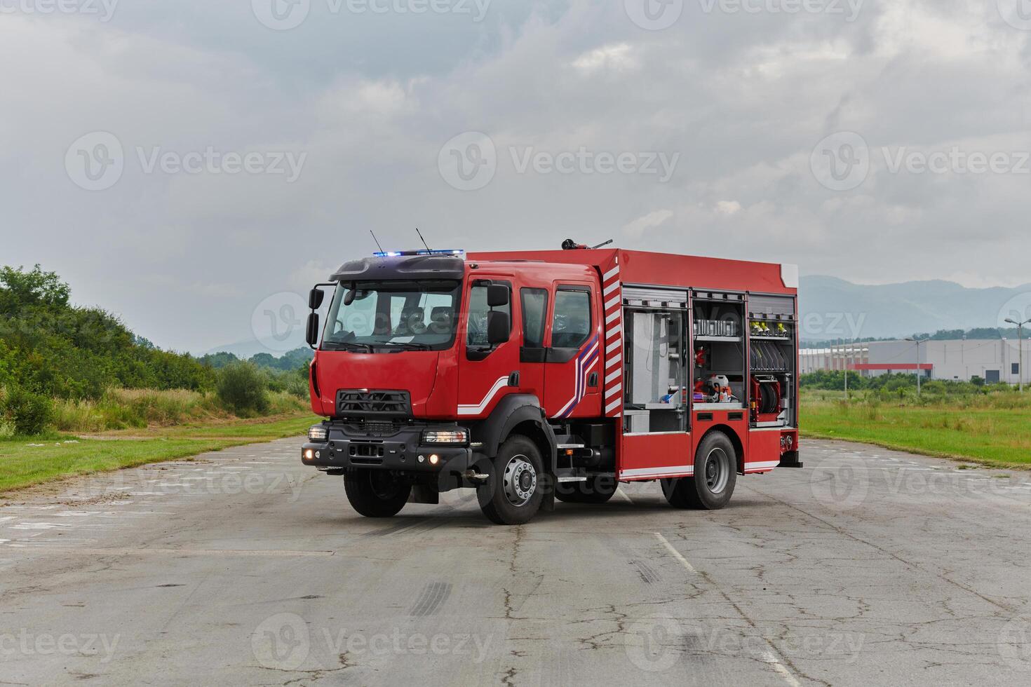 In this captivating scene, a state-of-the-art firetruck, equipped with advanced rescue technology, stands ready with its skilled firefighting team, prepared to intervene and respond rapidly to photo