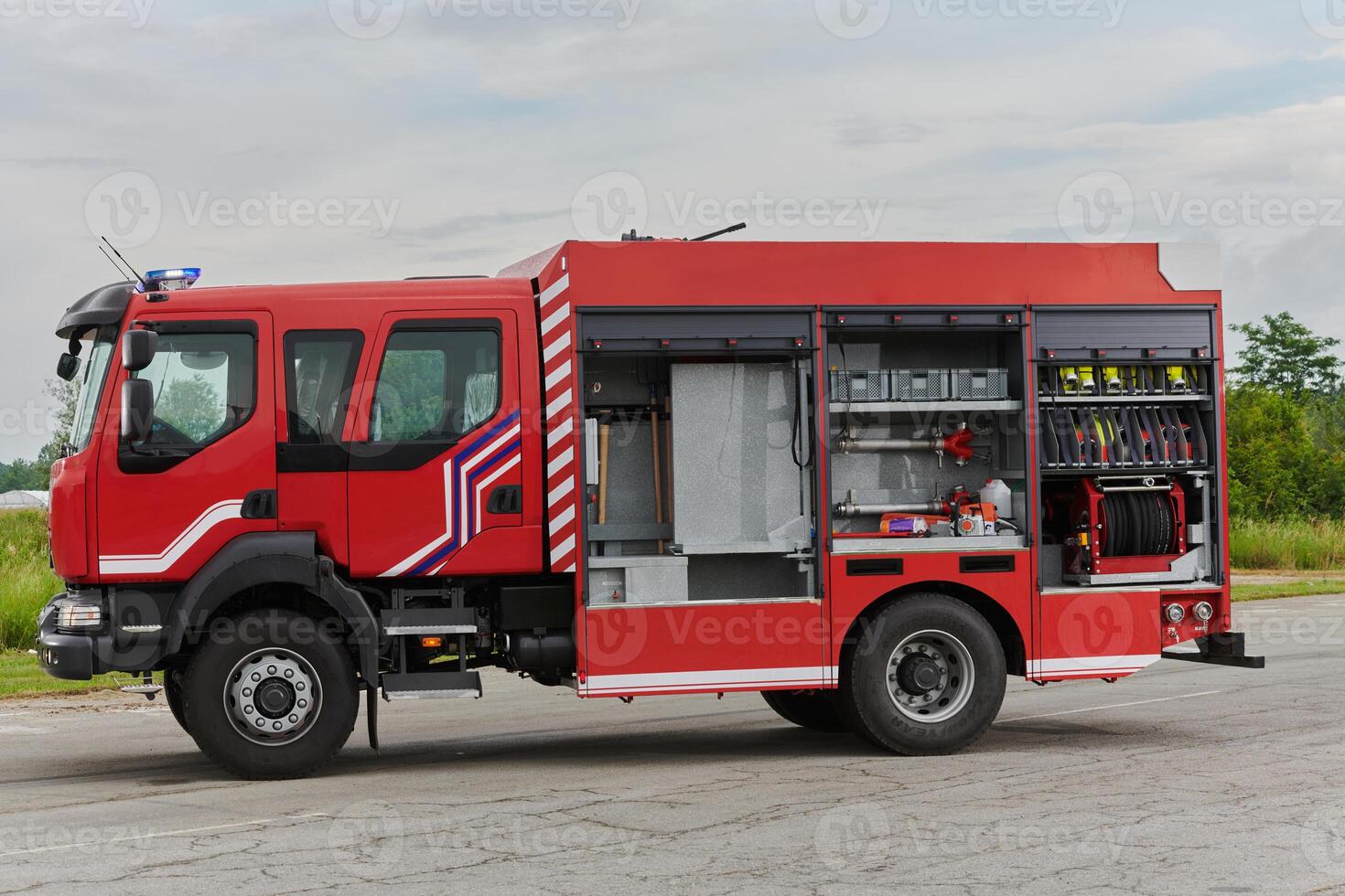 In this captivating scene, a state-of-the-art firetruck, equipped with advanced rescue technology, stands ready with its skilled firefighting team, prepared to intervene and respond rapidly to photo