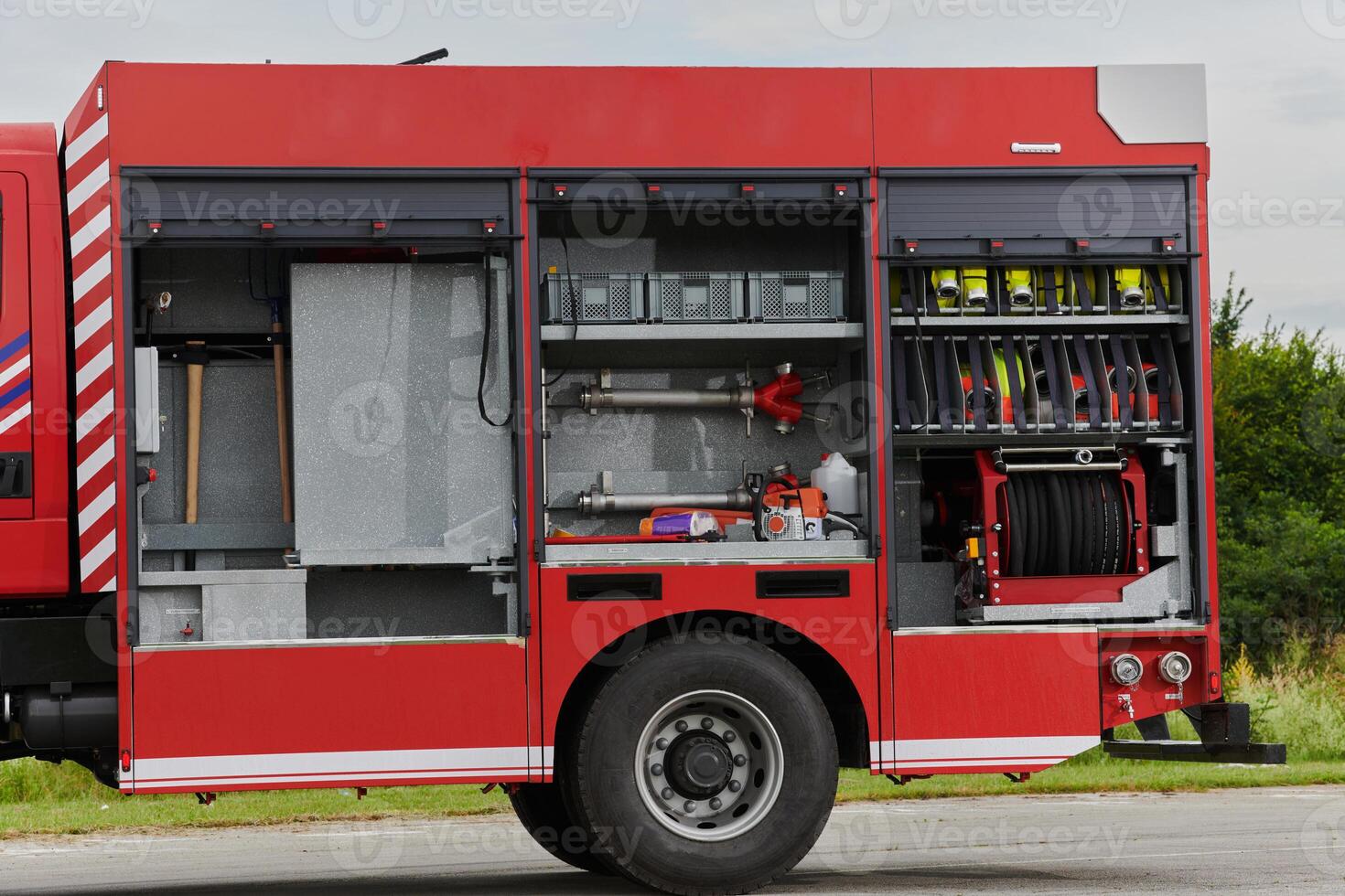 In this captivating scene, a state-of-the-art firetruck, equipped with advanced rescue technology, stands ready with its skilled firefighting team, prepared to intervene and respond rapidly to photo