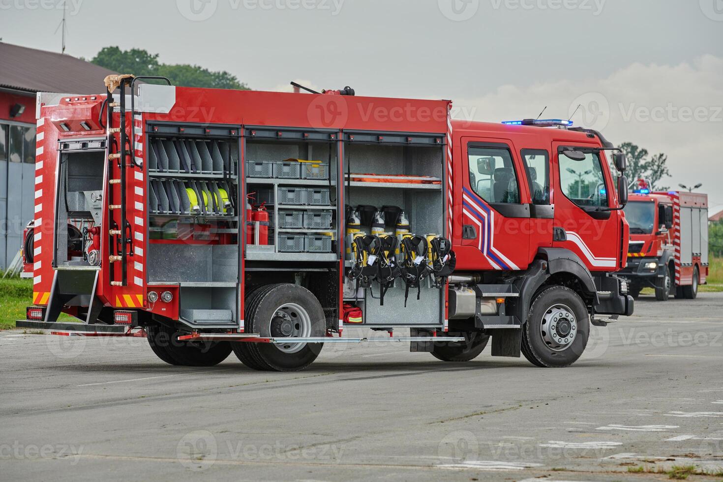 In this captivating scene, a state-of-the-art firetruck, equipped with advanced rescue technology, stands ready with its skilled firefighting team, prepared to intervene and respond rapidly to photo