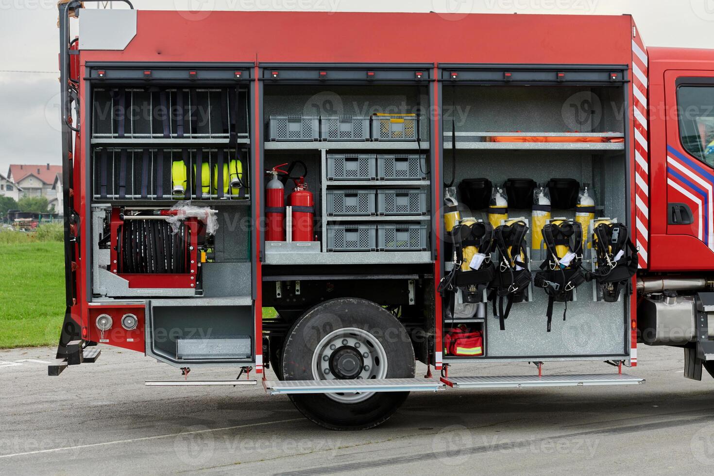 In this captivating scene, a state-of-the-art firetruck, equipped with advanced rescue technology, stands ready with its skilled firefighting team, prepared to intervene and respond rapidly to photo