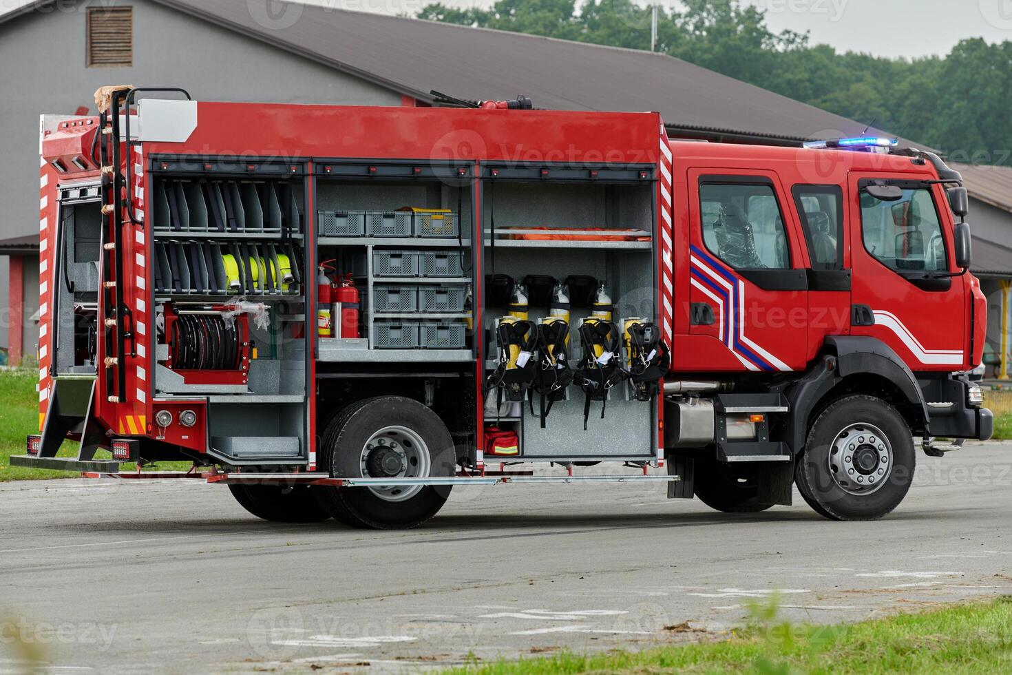In this captivating scene, a state-of-the-art firetruck, equipped with advanced rescue technology, stands ready with its skilled firefighting team, prepared to intervene and respond rapidly to photo