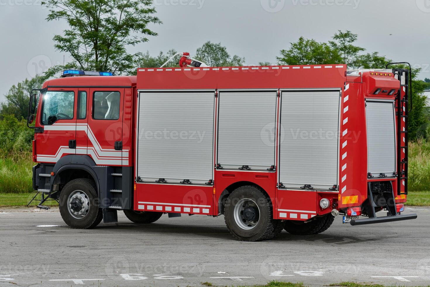 In this captivating scene, a state-of-the-art firetruck, equipped with advanced rescue technology, stands ready with its skilled firefighting team, prepared to intervene and respond rapidly to photo