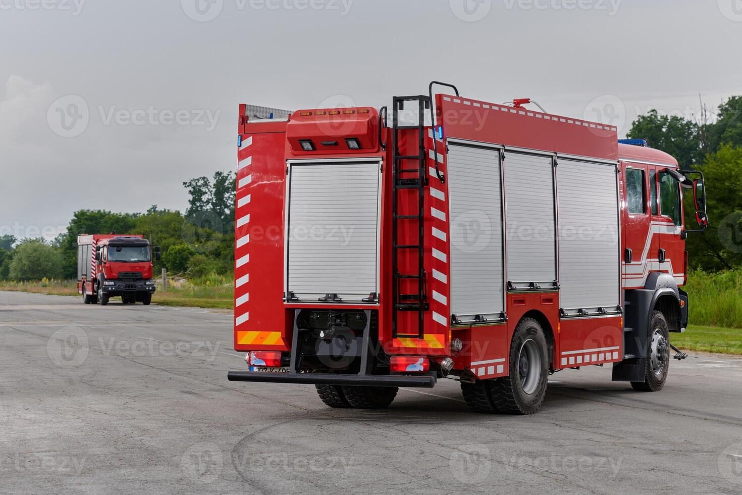 In this captivating scene, a state-of-the-art firetruck, equipped with advanced rescue technology, stands ready with its skilled firefighting team, prepared to intervene and respond rapidly to photo