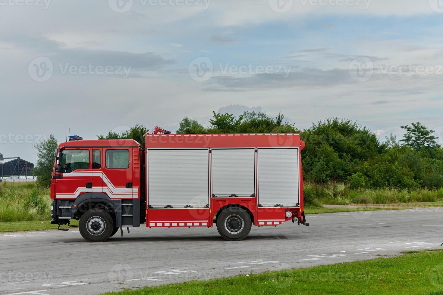 In this captivating scene, a state-of-the-art firetruck, equipped with advanced rescue technology, stands ready with its skilled firefighting team, prepared to intervene and respond rapidly to photo