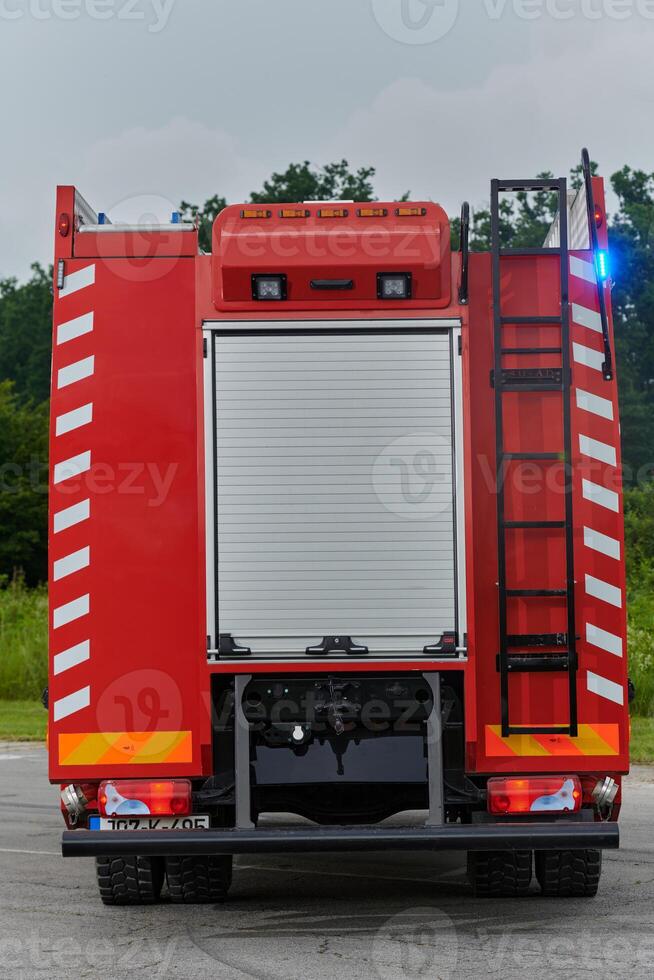 In this captivating scene, a state-of-the-art firetruck, equipped with advanced rescue technology, stands ready with its skilled firefighting team, prepared to intervene and respond rapidly to photo