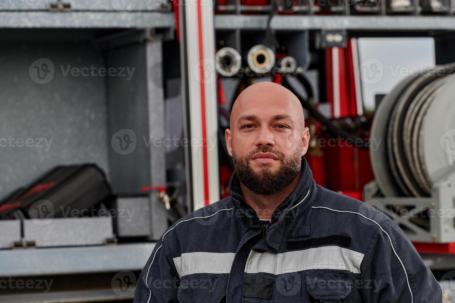 A firefighter meticulously prepares a modern firetruck for a mission to evacuate and respond to dangerous situations, showcasing the utmost dedication to safety and readiness in the face of a fire photo