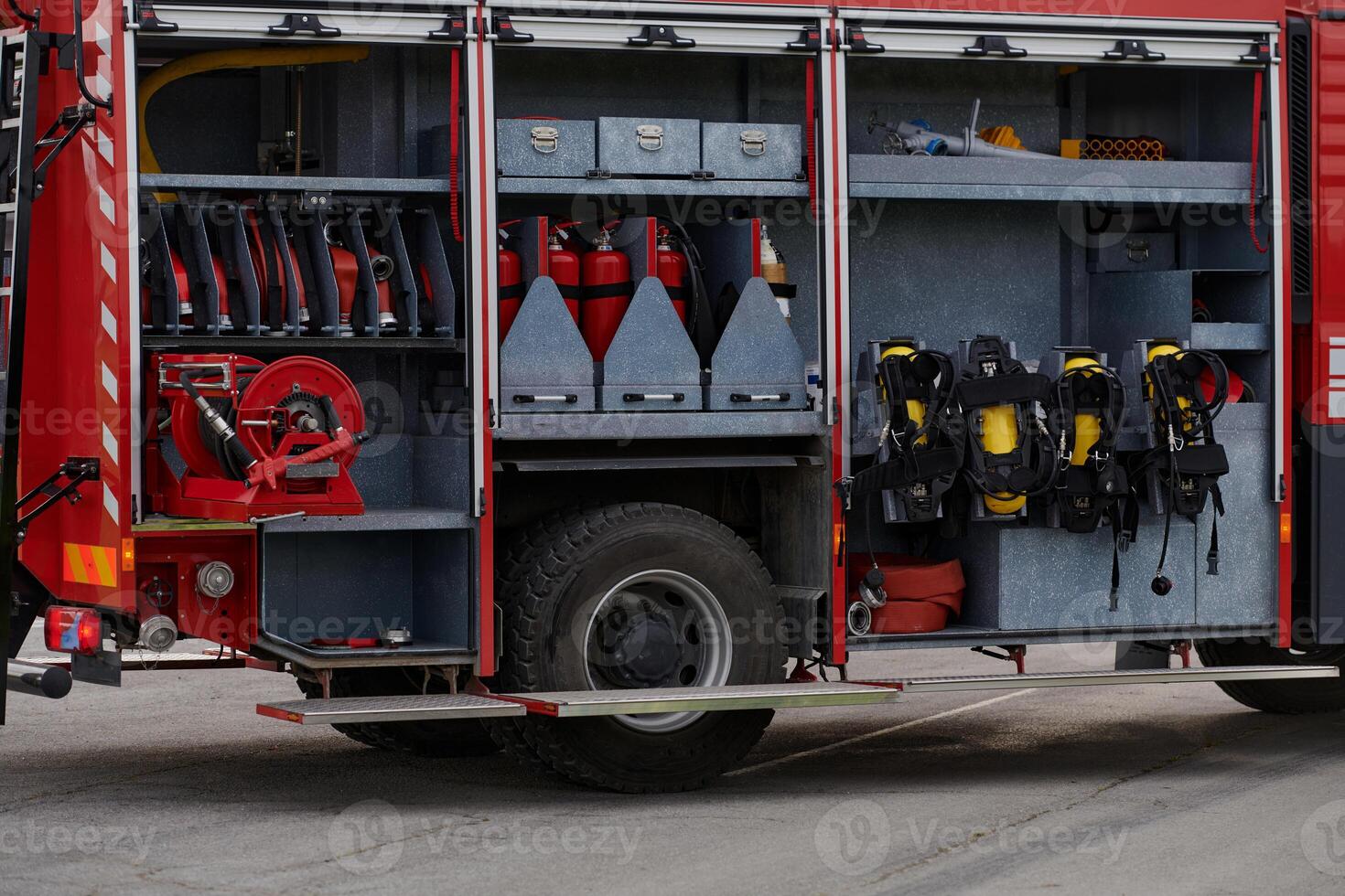 In this captivating scene, a state-of-the-art firetruck, equipped with advanced rescue technology, stands ready with its skilled firefighting team, prepared to intervene and respond rapidly to photo