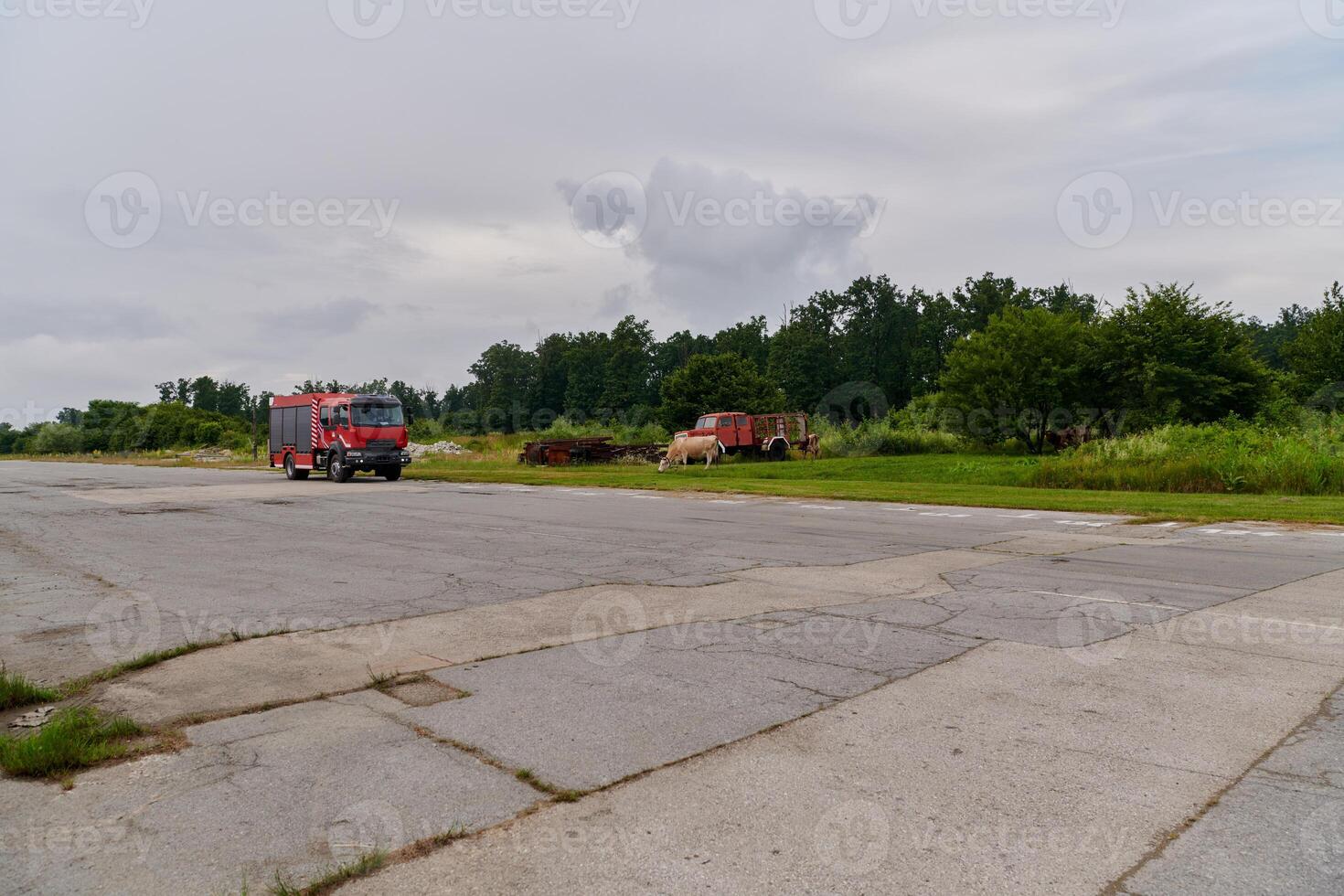 In this captivating scene, a state-of-the-art firetruck, equipped with advanced rescue technology, stands ready with its skilled firefighting team, prepared to intervene and respond rapidly to photo
