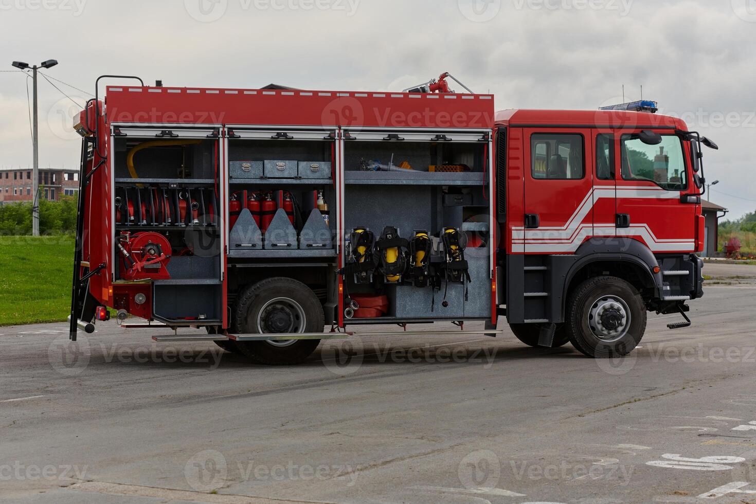 In this captivating scene, a state-of-the-art firetruck, equipped with advanced rescue technology, stands ready with its skilled firefighting team, prepared to intervene and respond rapidly to photo