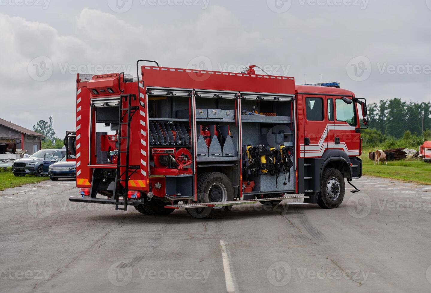 In this captivating scene, a state-of-the-art firetruck, equipped with advanced rescue technology, stands ready with its skilled firefighting team, prepared to intervene and respond rapidly to photo