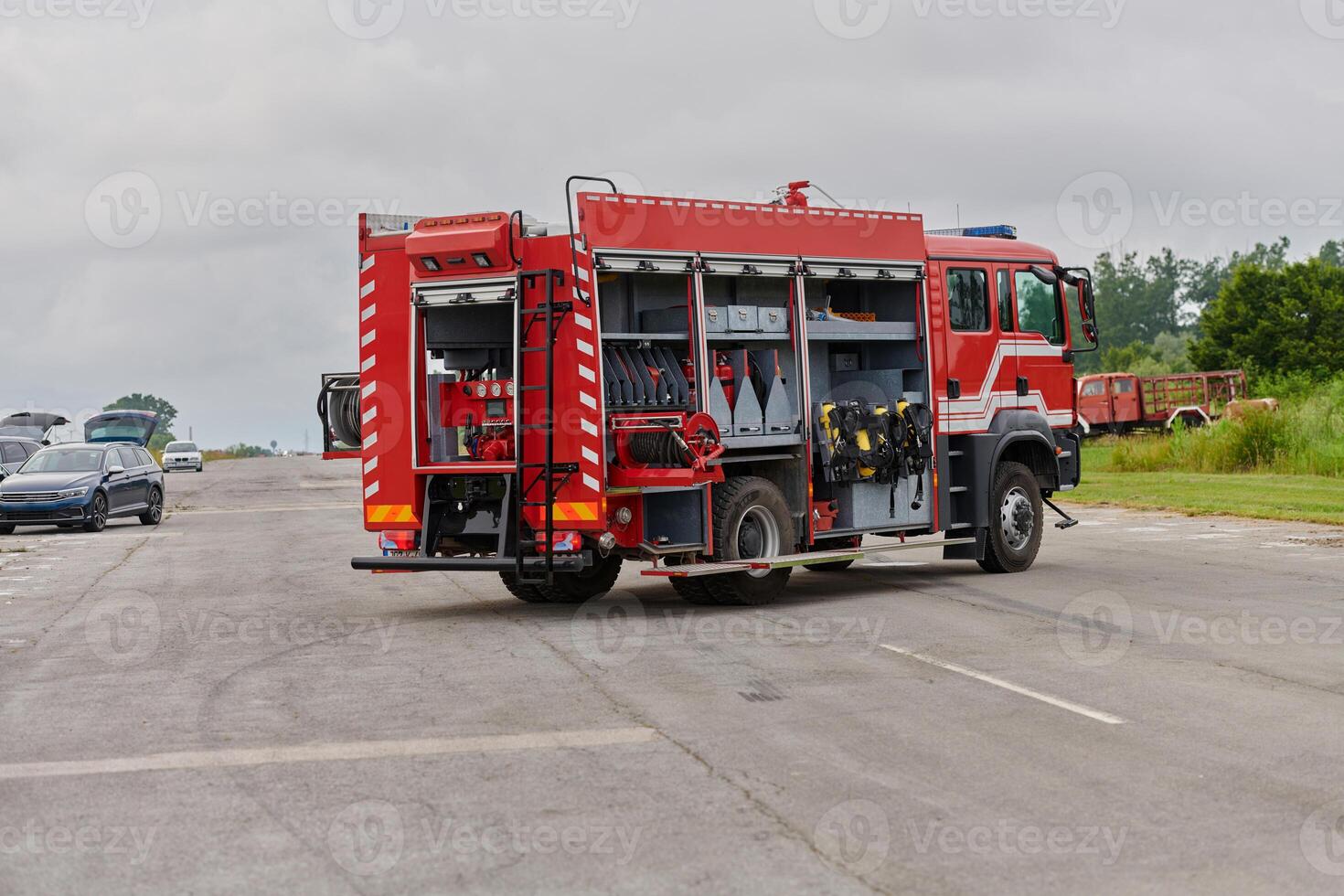 In this captivating scene, a state-of-the-art firetruck, equipped with advanced rescue technology, stands ready with its skilled firefighting team, prepared to intervene and respond rapidly to photo
