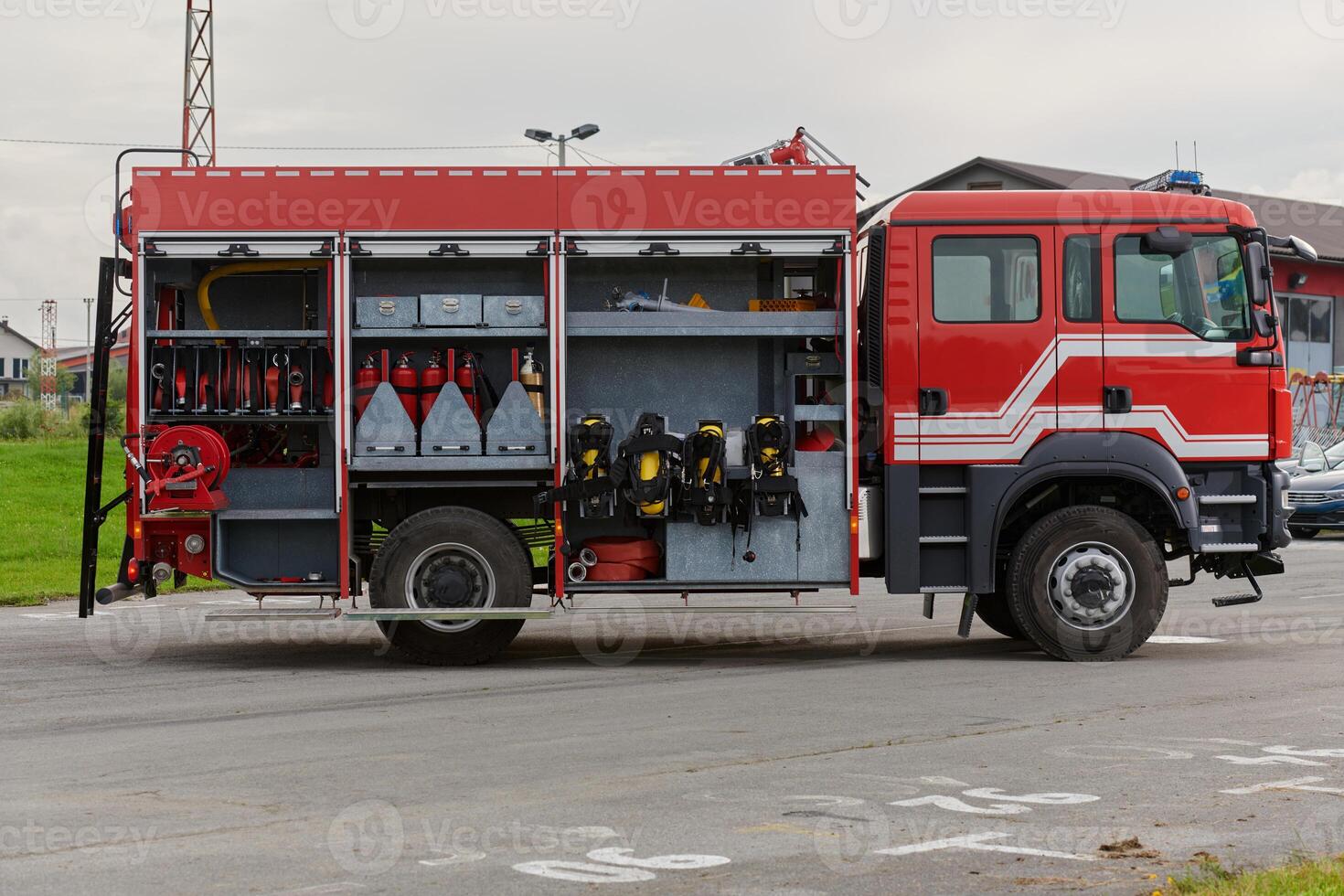 In this captivating scene, a state-of-the-art firetruck, equipped with advanced rescue technology, stands ready with its skilled firefighting team, prepared to intervene and respond rapidly to photo