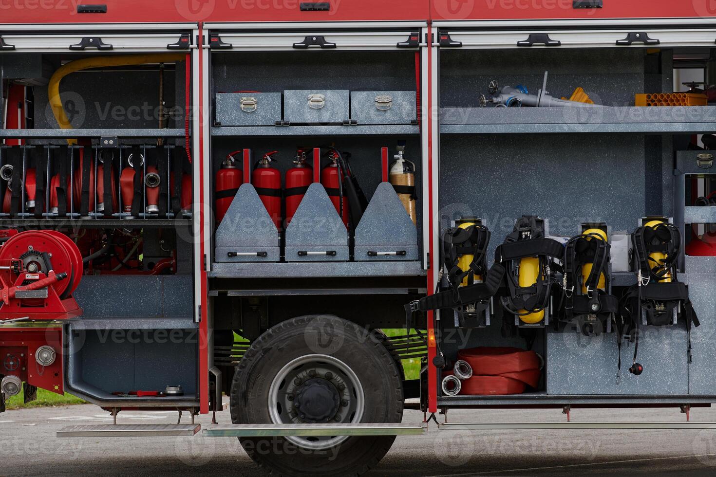 In this captivating scene, a state-of-the-art firetruck, equipped with advanced rescue technology, stands ready with its skilled firefighting team, prepared to intervene and respond rapidly to photo