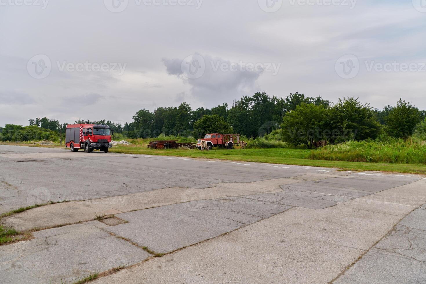 In this captivating scene, a state-of-the-art firetruck, equipped with advanced rescue technology, stands ready with its skilled firefighting team, prepared to intervene and respond rapidly to photo