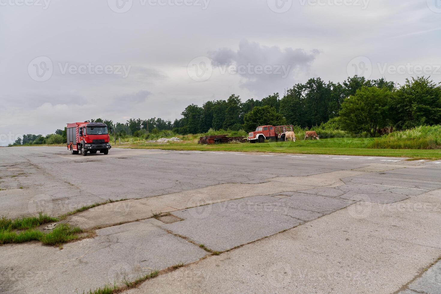 In this captivating scene, a state-of-the-art firetruck, equipped with advanced rescue technology, stands ready with its skilled firefighting team, prepared to intervene and respond rapidly to photo