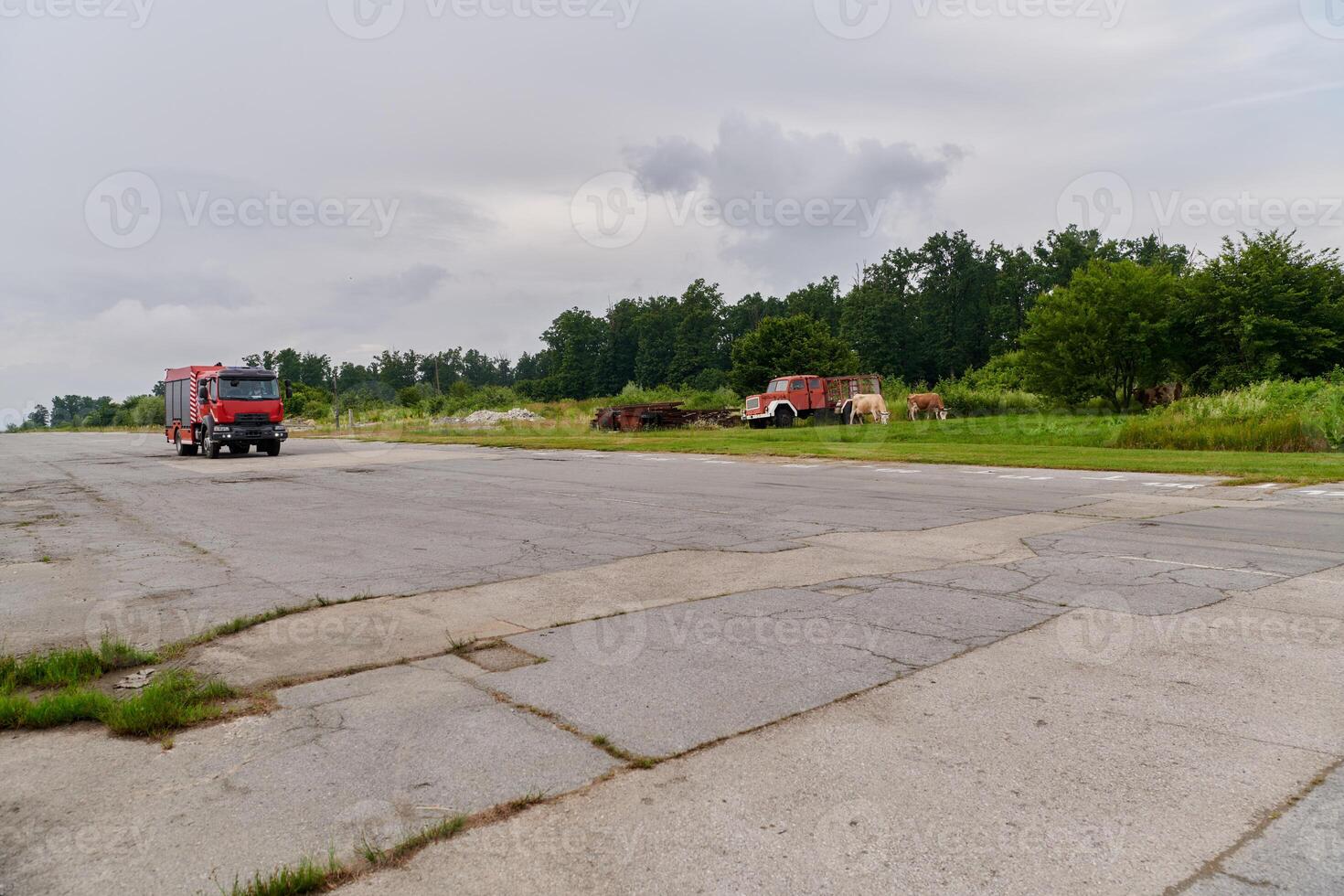 In this captivating scene, a state-of-the-art firetruck, equipped with advanced rescue technology, stands ready with its skilled firefighting team, prepared to intervene and respond rapidly to photo