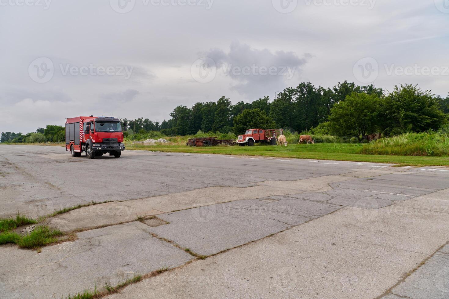 In this captivating scene, a state-of-the-art firetruck, equipped with advanced rescue technology, stands ready with its skilled firefighting team, prepared to intervene and respond rapidly to photo