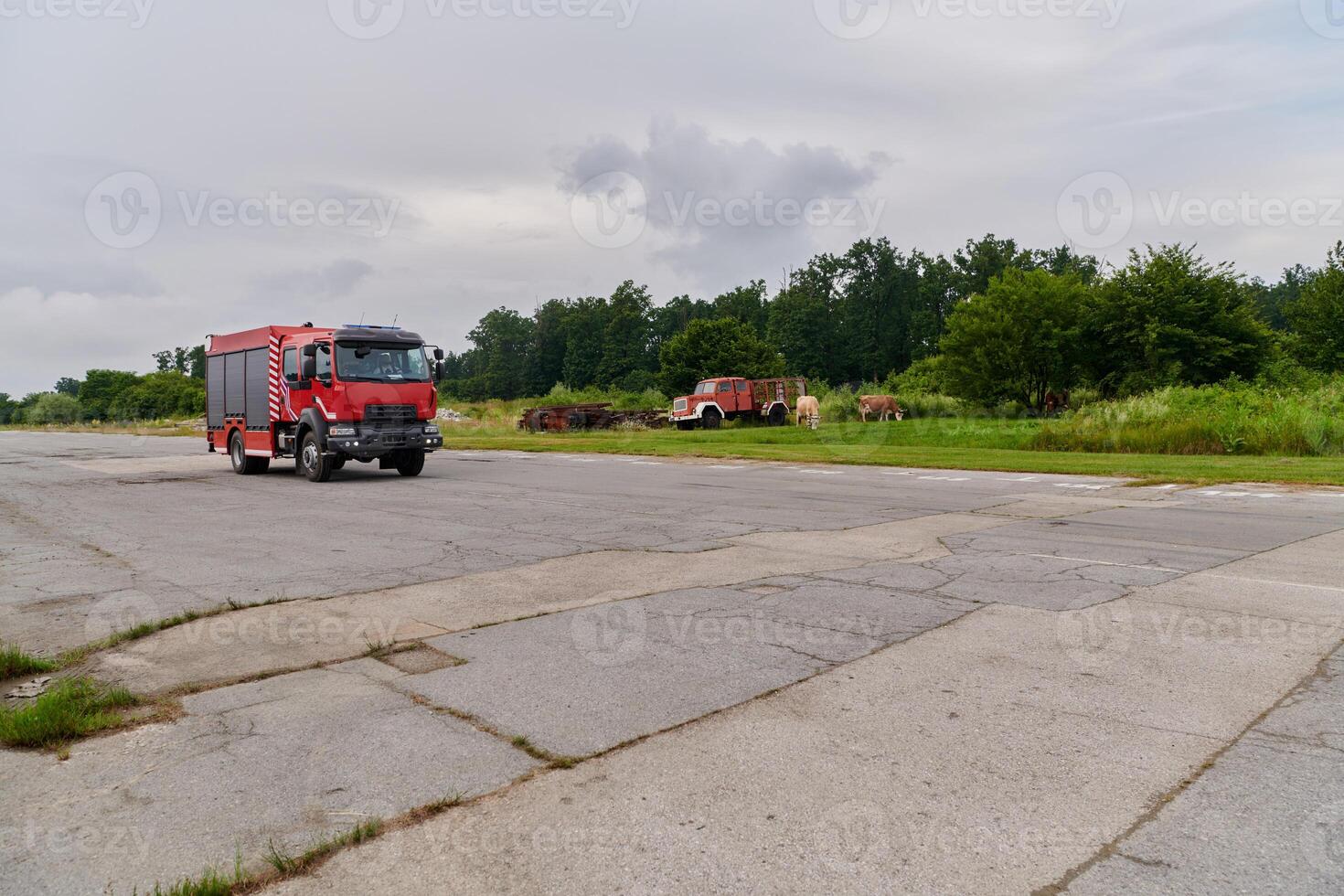 In this captivating scene, a state-of-the-art firetruck, equipped with advanced rescue technology, stands ready with its skilled firefighting team, prepared to intervene and respond rapidly to photo
