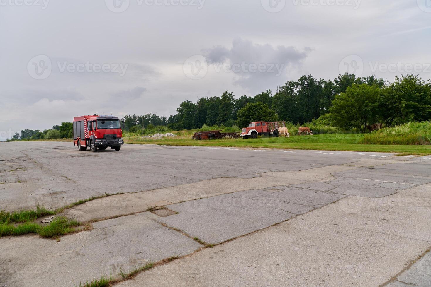 In this captivating scene, a state-of-the-art firetruck, equipped with advanced rescue technology, stands ready with its skilled firefighting team, prepared to intervene and respond rapidly to photo